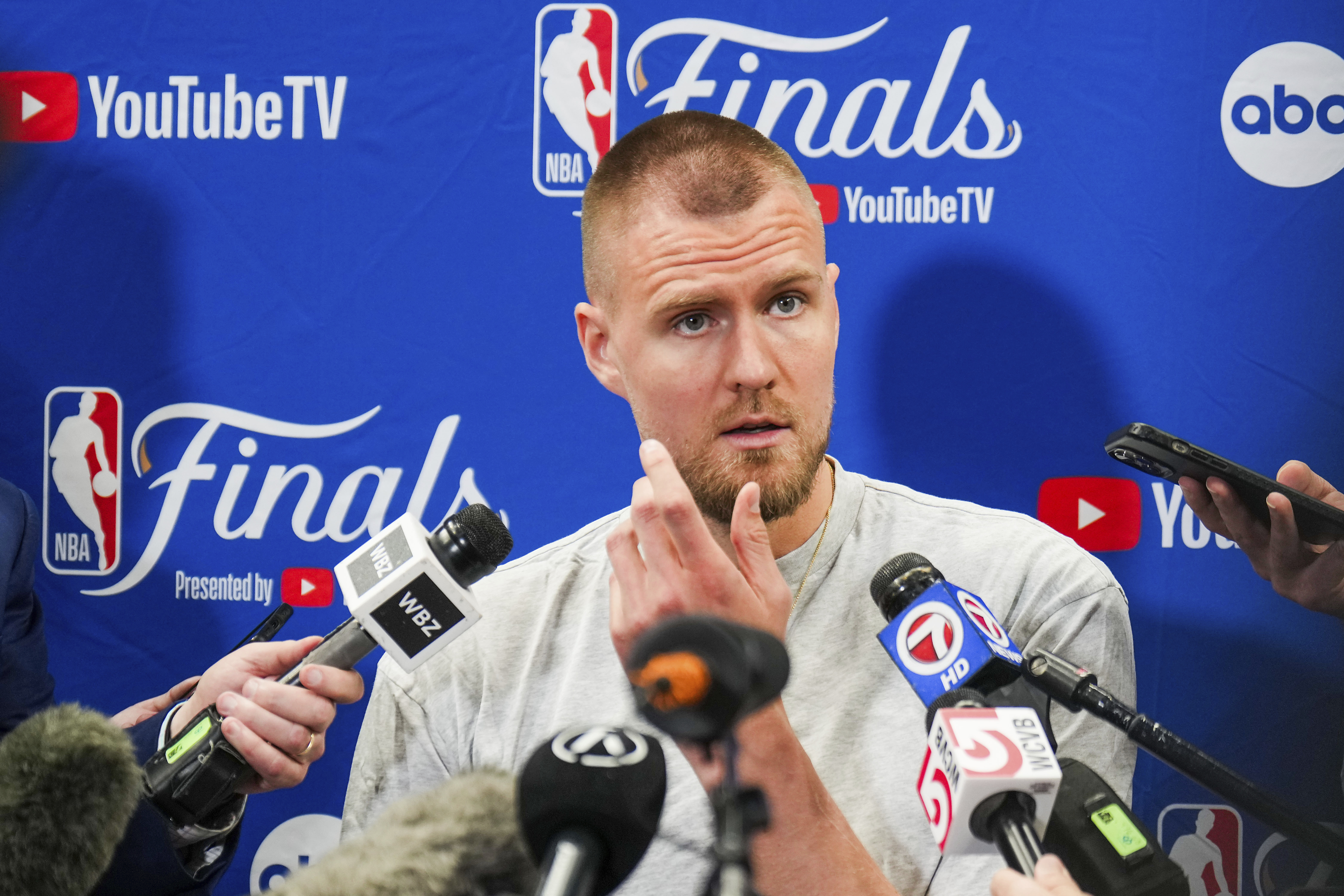 Boston Celtics center Kristaps Porzingis talks with reporters before basketball practice, Tuesday, June 11, 2024, in Dallas, in preparation for Game 3 of the NBA Finals against the Dallas Mavericks. 