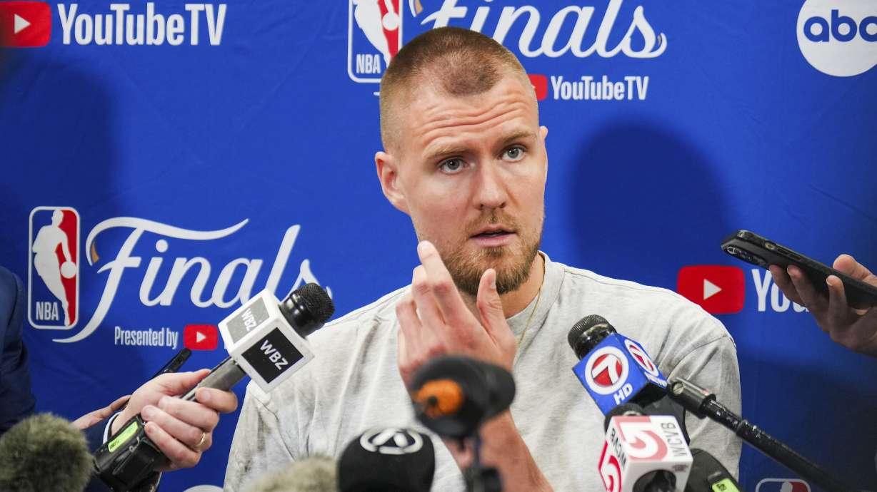 Boston Celtics center Kristaps Porzingis talks with reporters before basketball practice, Tuesday, June 11, 2024, in Dallas, in preparation for Game 3 of the NBA Finals against the Dallas Mavericks.