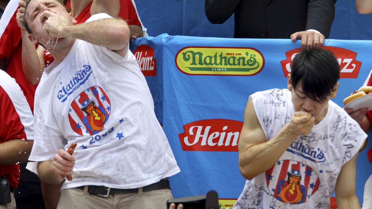 FILE - Joey Chestnut, defending champion of the Nathan’s Famous Fourth of July hot dog eating contest, left, works to outpace former champion Takeru Kobayashi, right, July 4, 2009, in New York. Chestnut, a 16-time hot dog-eating champion, will face off with his frequent Nathan’s competitor, Kobayashi, in a live Netflix special on Sept. 2, 2024, the streamer announced Wednesday, June 12.