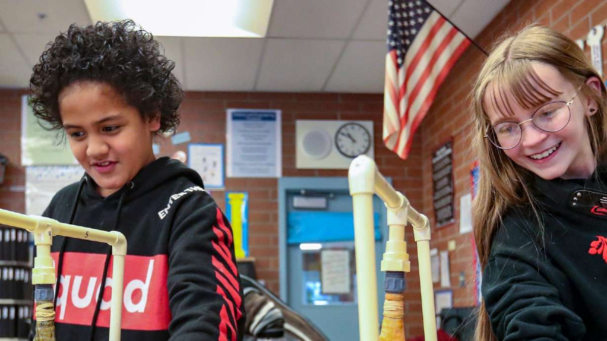 Noah Kinikini and Roxann Christopherson feel a diseased pig lung and a healthy pig lung, respectively, while learning about the dangers of vaping, nicotine and tobacco products, at Hawthorn Elementary School in Salt Lake City on Feb. 6, 2020. Two Utah lawmakers are among those calling for the Justice Department to crack down on teen vaping and illegal e-cigarettes.