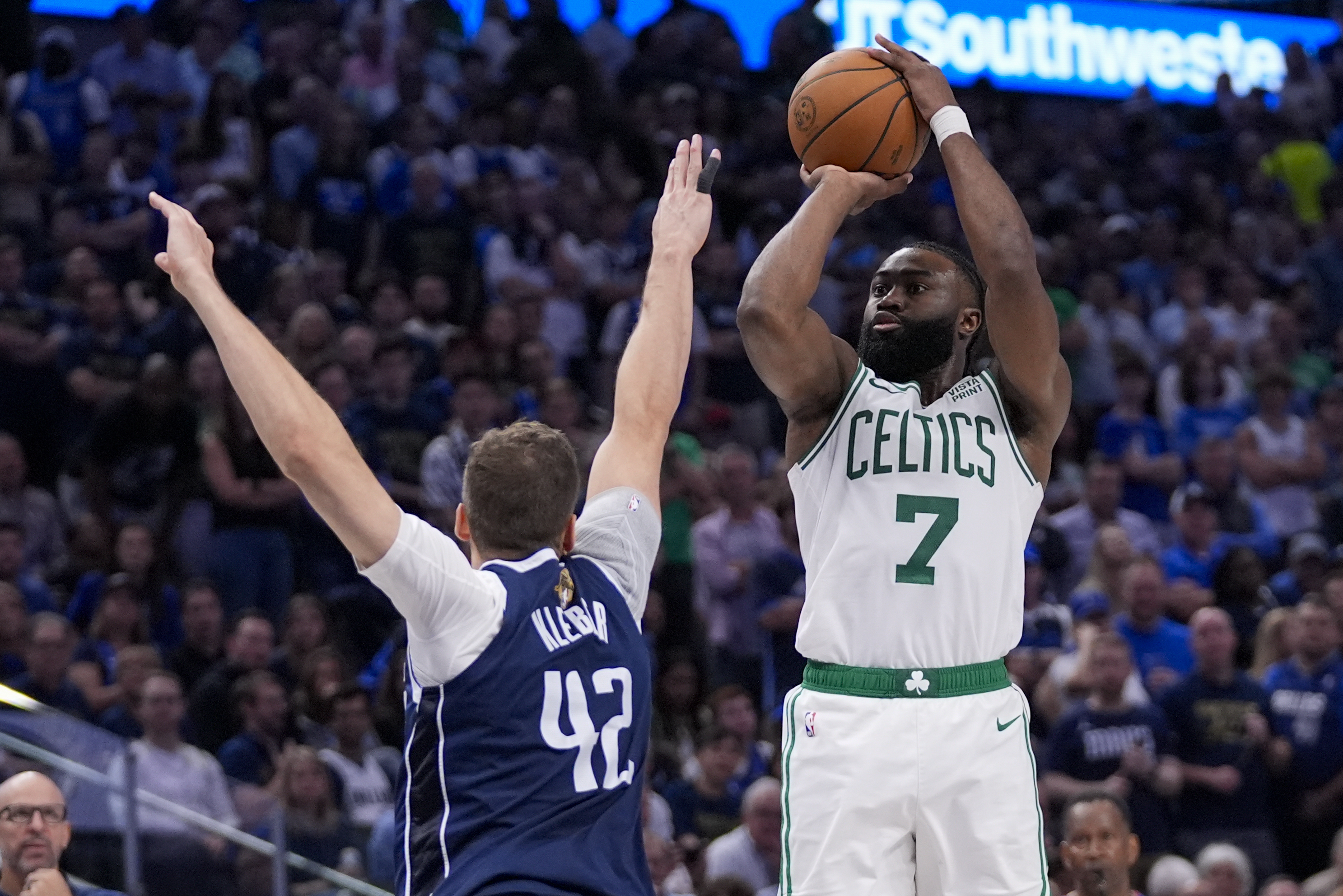 Boston Celtics guard Jaylen Brown (7) shoots against Dallas Mavericks forward Maxi Kleber (42) during the second half in Game 3 of the NBA basketball finals, Wednesday, June 12, 2024, in Dallas. 