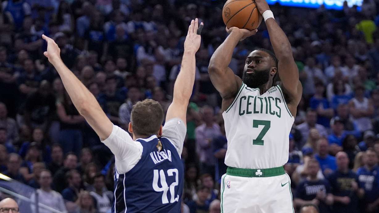 Boston Celtics guard Jaylen Brown (7) shoots against Dallas Mavericks forward Maxi Kleber (42) during the second half in Game 3 of the NBA basketball finals, Wednesday, June 12, 2024, in Dallas.