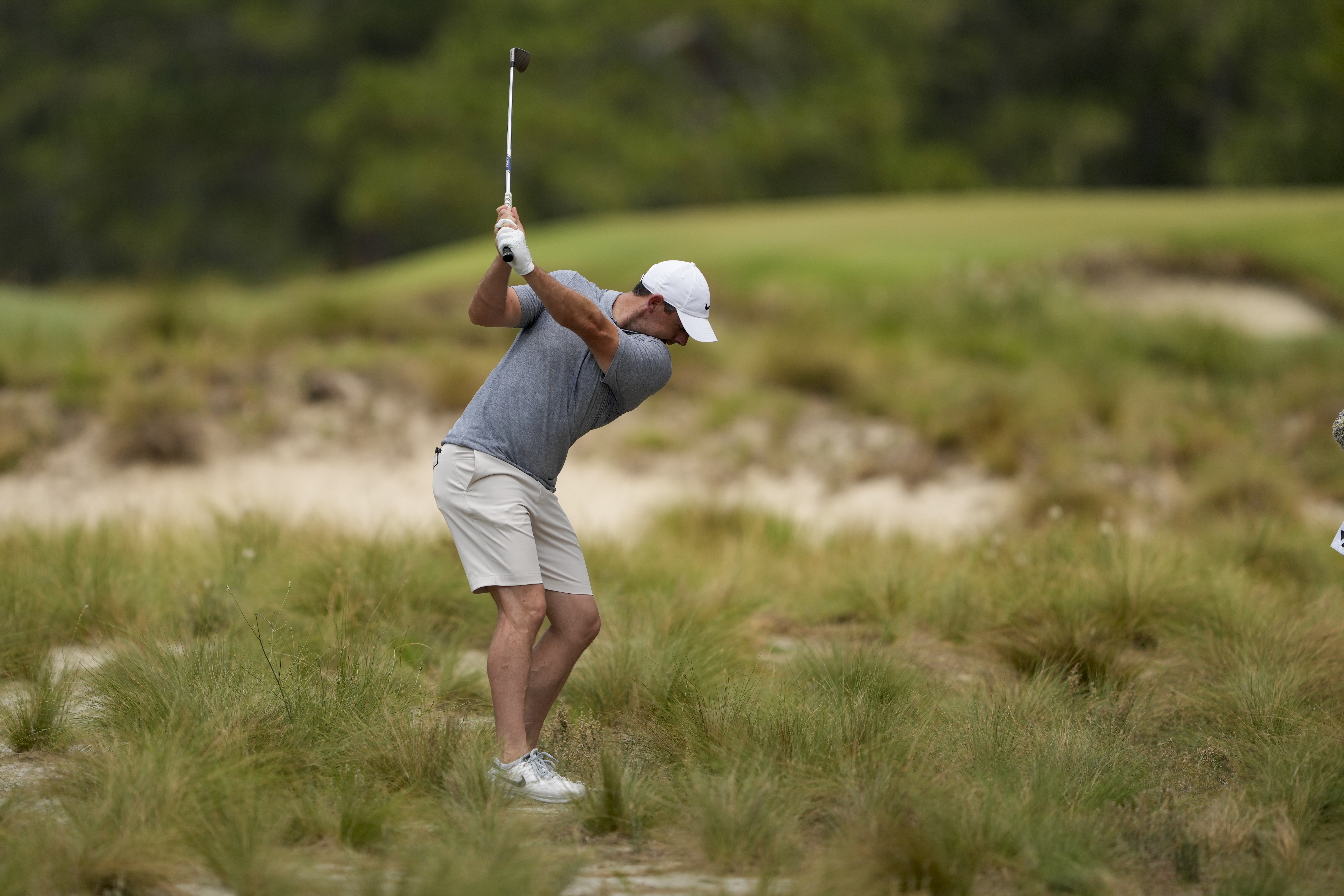 Rory McIlroy, of Northern Ireland, hits from the native area on the third hole during a practice round for the U.S. Open golf tournament Wednesday, June 12, 2024, in Pinehurst, N.C. 