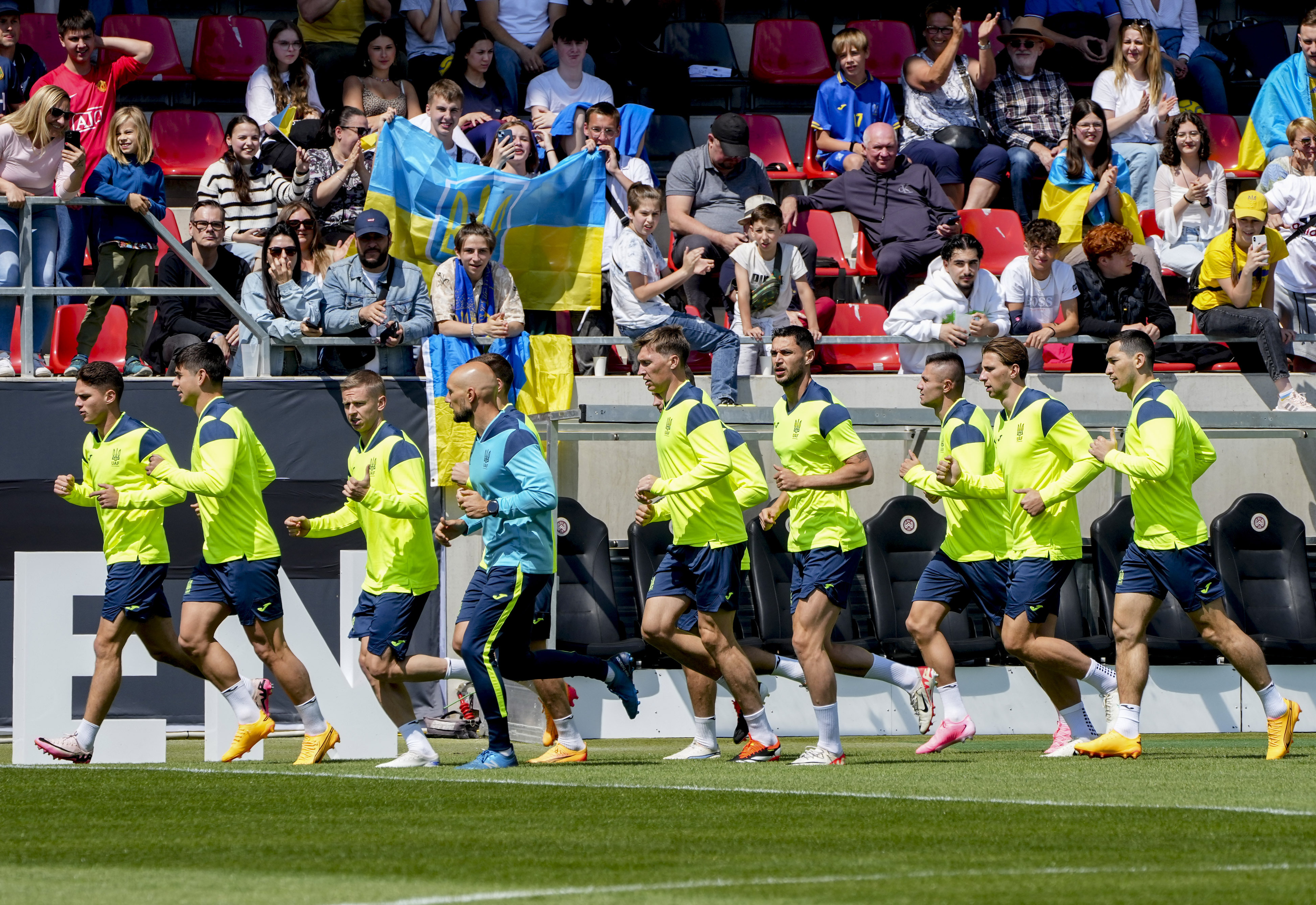 Players of Ukraine's national soccer team warm up during a public training session in Wiesbaden, Germany, Thursday, June 13, 2024, ahead of their group E match against Romania at the Euro 2024 soccer tournament.