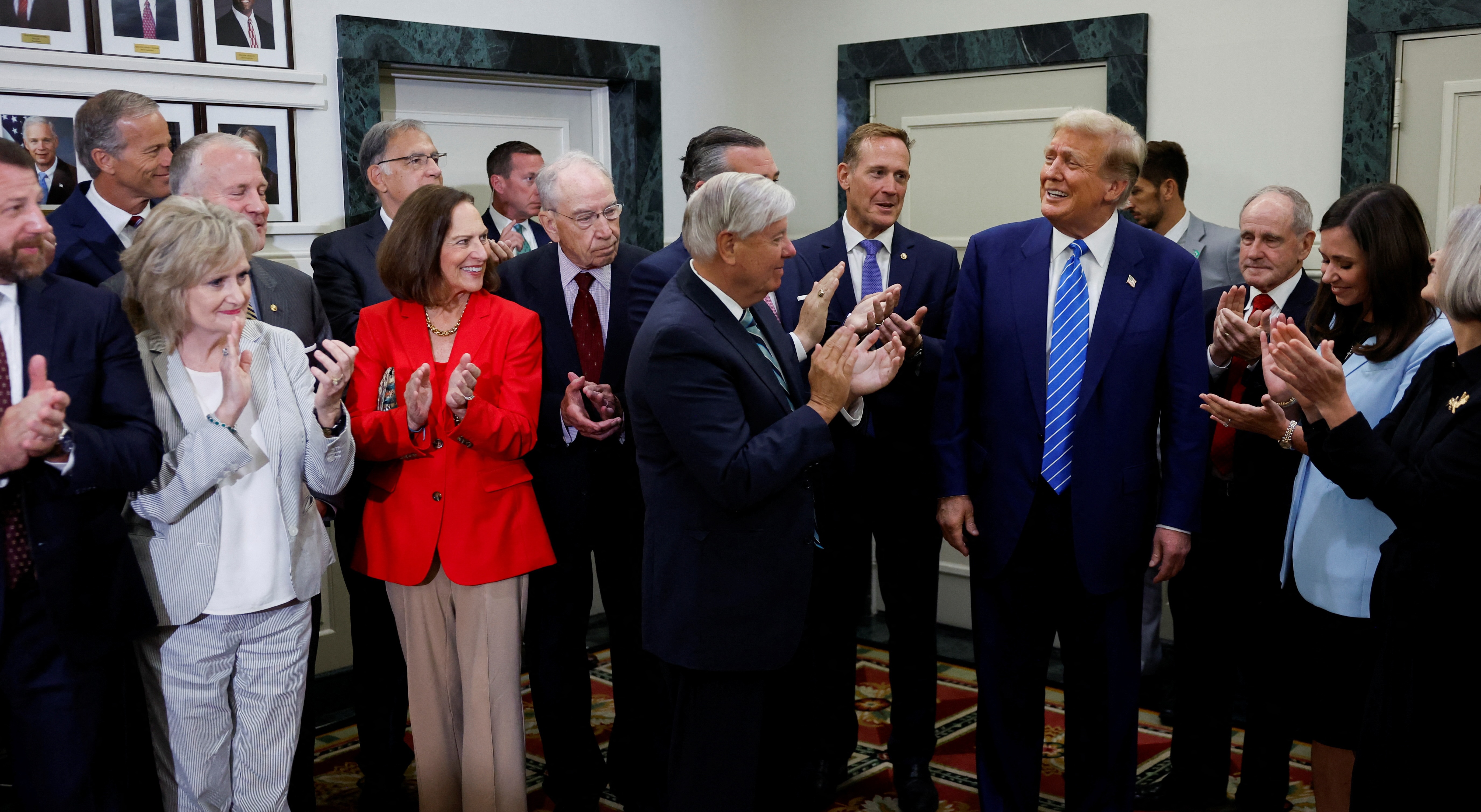 Former president and Republican presidential candidate Donald Trump is applauded by Republicans at the National Republican Senatorial Committee headquarters in Washington, Thursday, in his first public Capitol Hill visit since Jan. 6, 2021.
