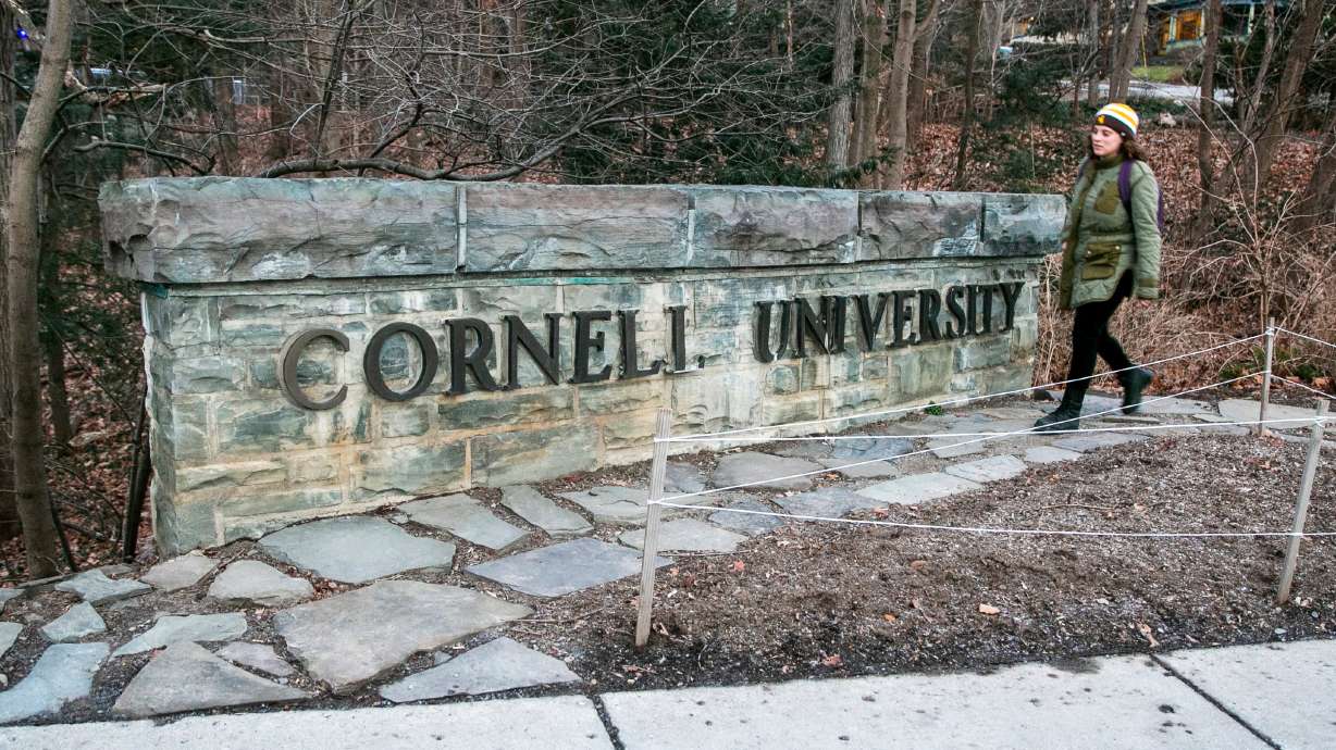 A woman walks by a Cornell University sign on the Ivy League school's campus, Jan. 14, 2022, in Ithaca, N.Y. Educators and politicians are asking what Congress or the executive branch could do about antisemitism on college campuses.