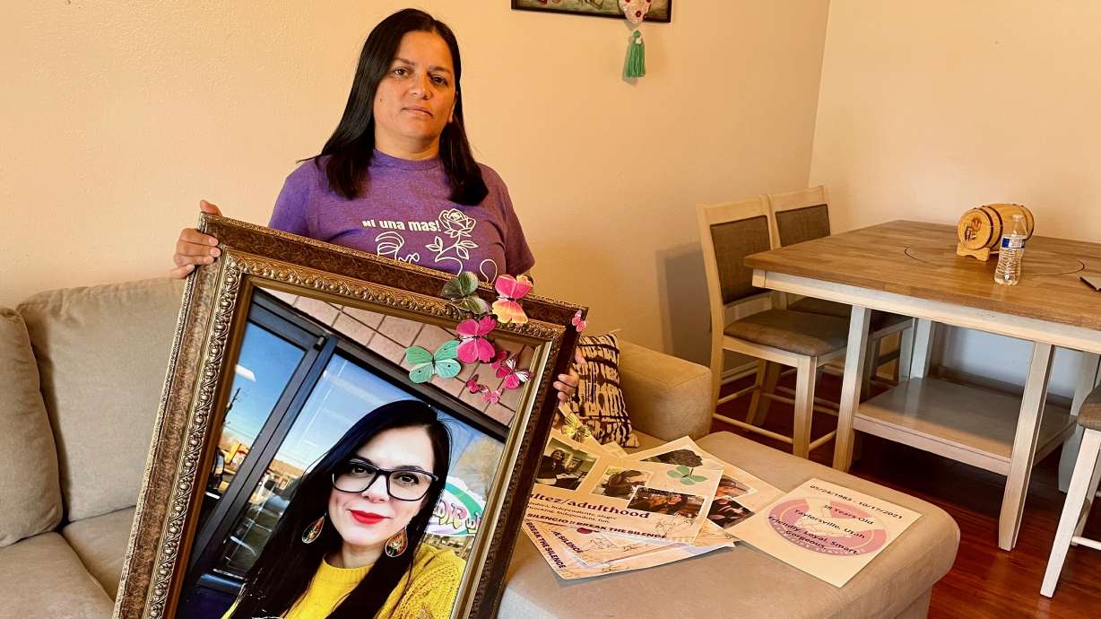 Rocio Cifuentes holds a picture of her sister, Gaby Ramos, allegedly killed at the hands of her ex-boyfriend in 2021, on Wednesday, June 12, 2024. The photo was taken at Cifuentes' Taylorsville home.