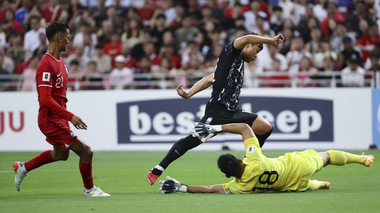 Hwang Hee Chan of South Korea tries to dribble past Hassan Sunny of Singapore during 2026 FIFA World Cup Asian 2nd Qualifier soccer match between Singapore and South Korea at the National Stadium in Singapore, on Thursday, June 6, 2024. Chinese soccer fans have poured their love — and money — into Hassan Sunny’s food stall after his performance in a game this week indirectly helped China advance to the third qualifying round for the World Cup in 2026.