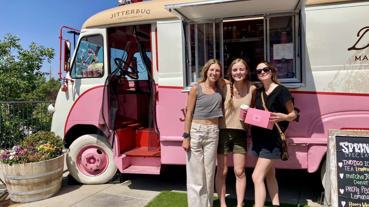 Jitterbug Coffee employee Lauren Rasich and managers Emma Beerman and Maizie Murphy show off a box of doughnuts, made fresh in the truck.