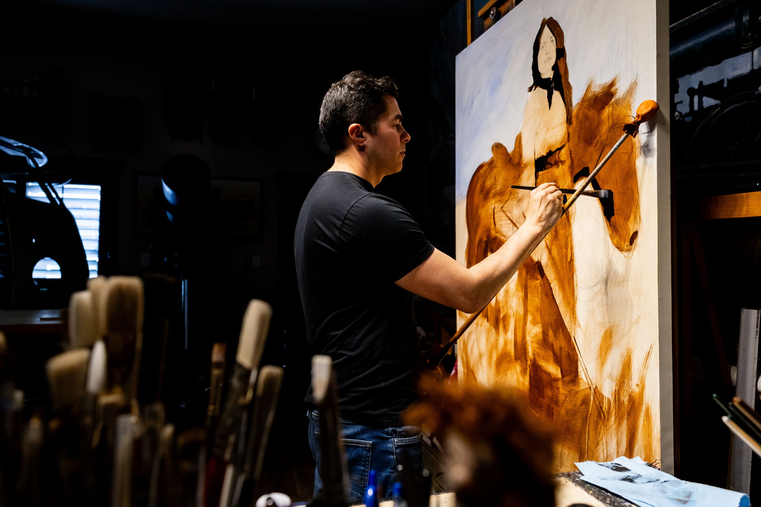 Santiago Michalek works on a painting of Annie Oakley in his studio at his home in Highland on June 7.