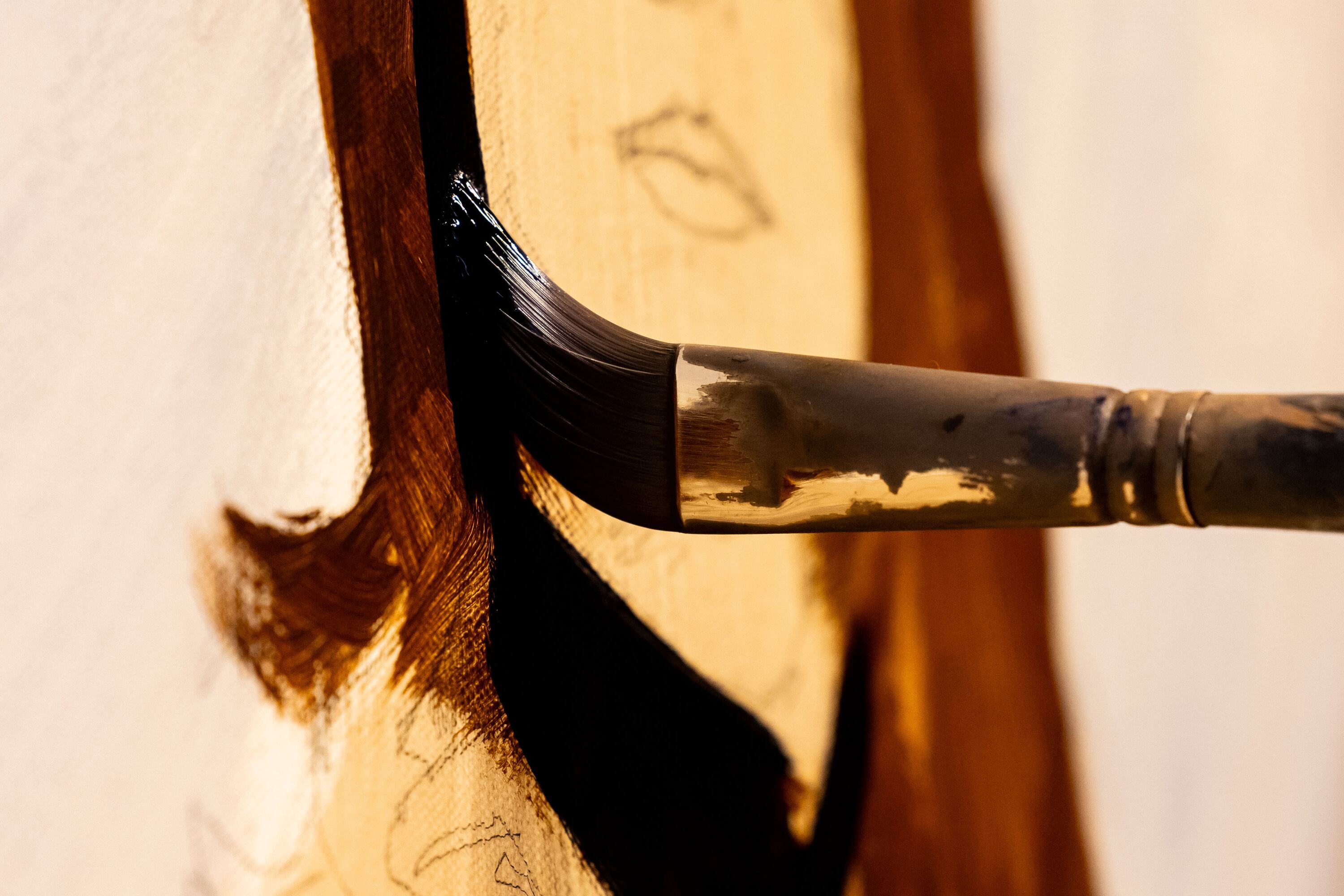 Santiago Michalek works on a painting of Annie Oakley in his studio at his home in Highland on June 7.