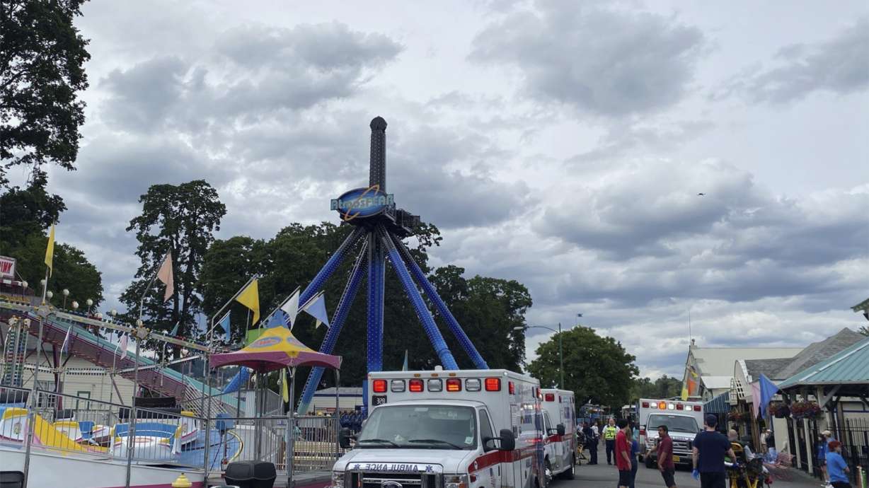 First responders arrive at Oaks Park for a ride that is stuck with multiple riders in Portland, Ore., Friday. Emergency crews have rescued 28 people after they were stuck for about half an hour dangling upside down high on a ride at a century-old amusement park in Oregon.