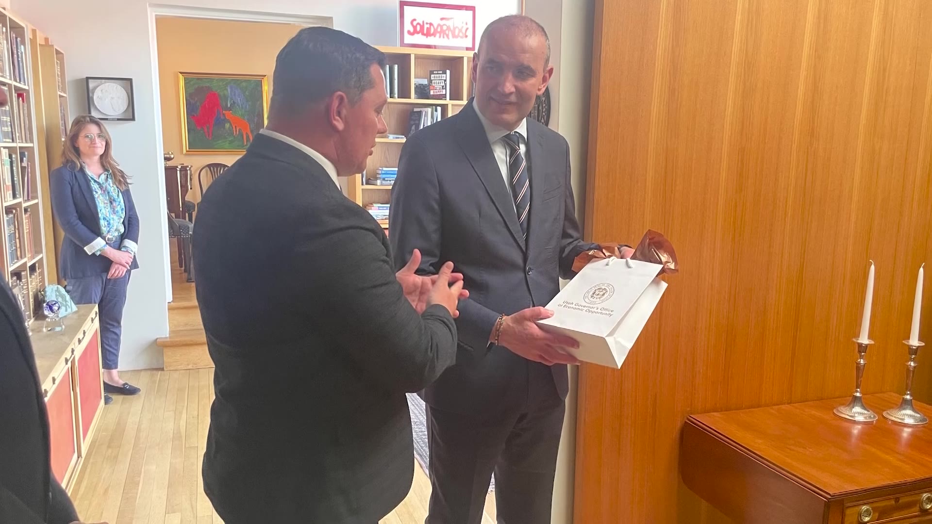 A Utah delegate gives Iceland President Guðni Th. Jóhannesson a gift. While the Utah delegation explored the state's potential of using geothermal energy in Iceland, a pioneer-era connection grew the bond between the two.