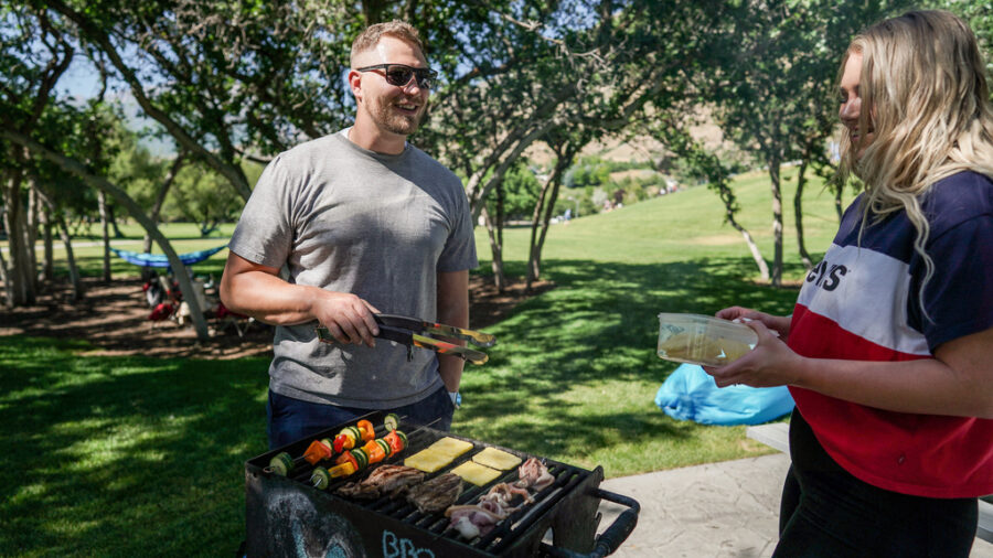 Jacob Anderson and his wife, Sam Anderson, grill with friends and family at Rock Canyon Park in Provo on July 4, 2020.