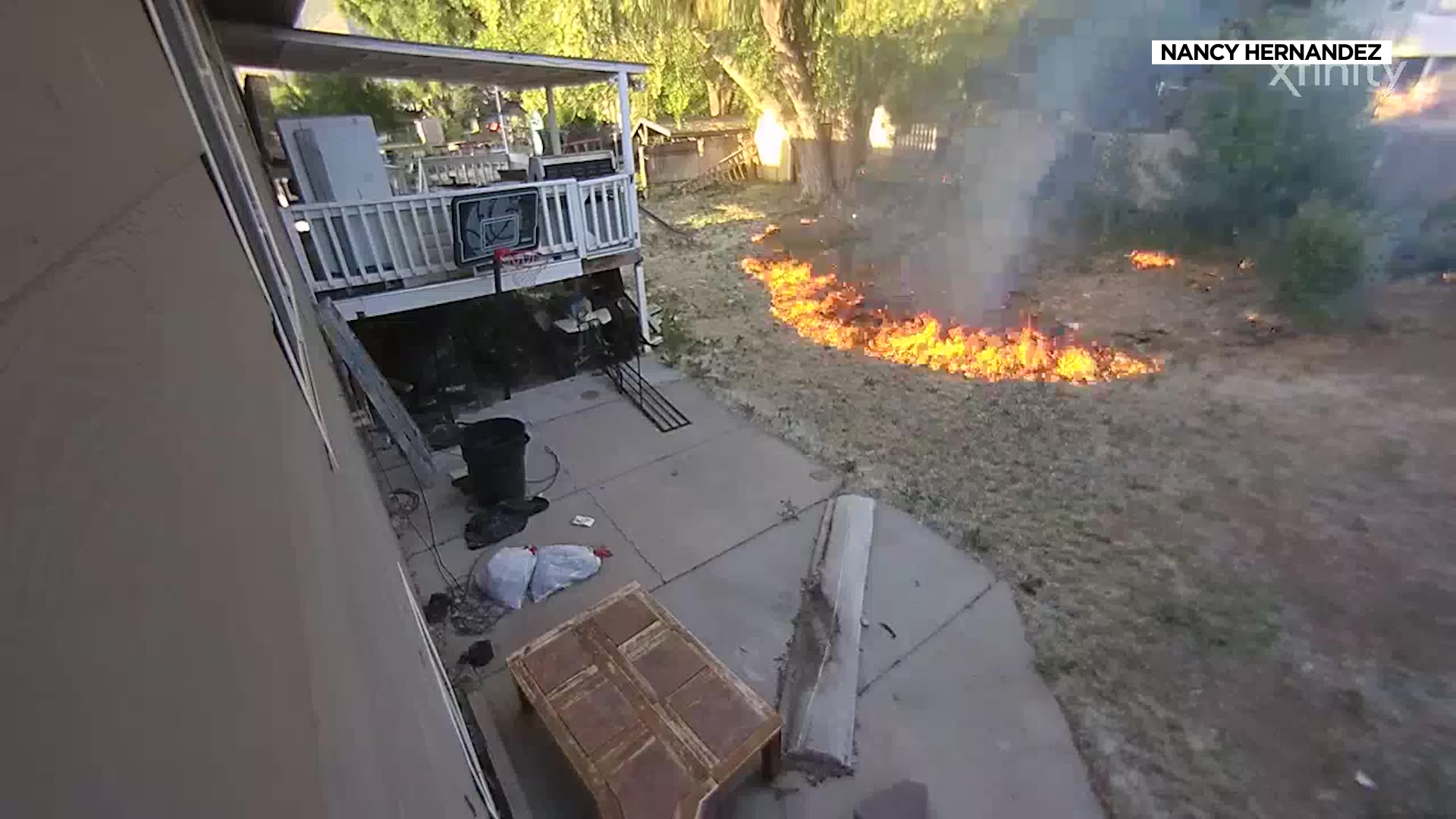 Security footage shows flames approaching a Springville home as the fire burns from another house.