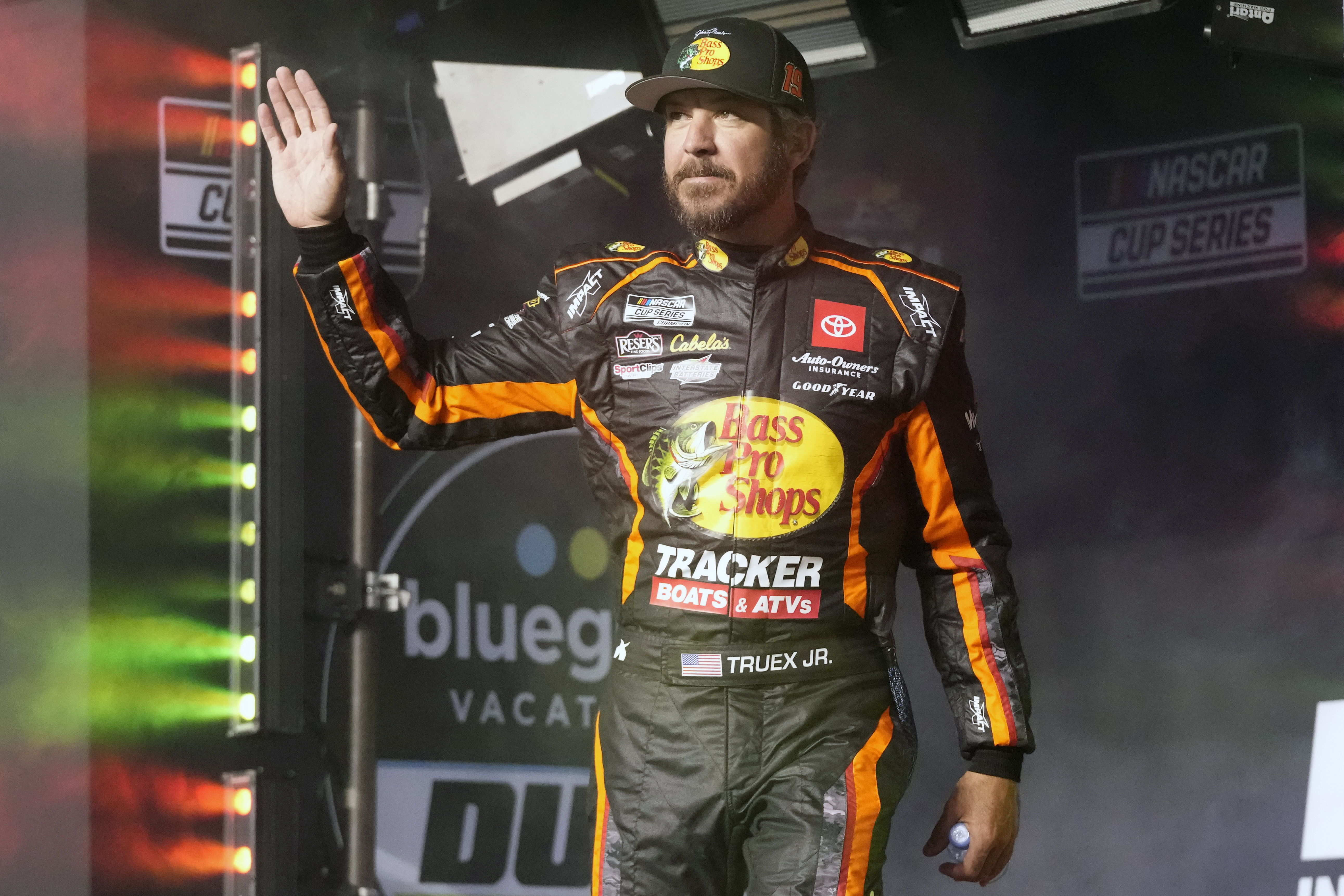FILE - Martin Truex Jr. waves to fans before Daytona 500 qualifying auto races at Daytona International Speedway, Feb. 15, 2024, in Daytona Beach, Fla. Truex announced his retirement from full-time racing Friday, June 14, 2024, saying it was time to live by his own schedule after 19 full-time seasons as a NASCAR Cup Series driver.