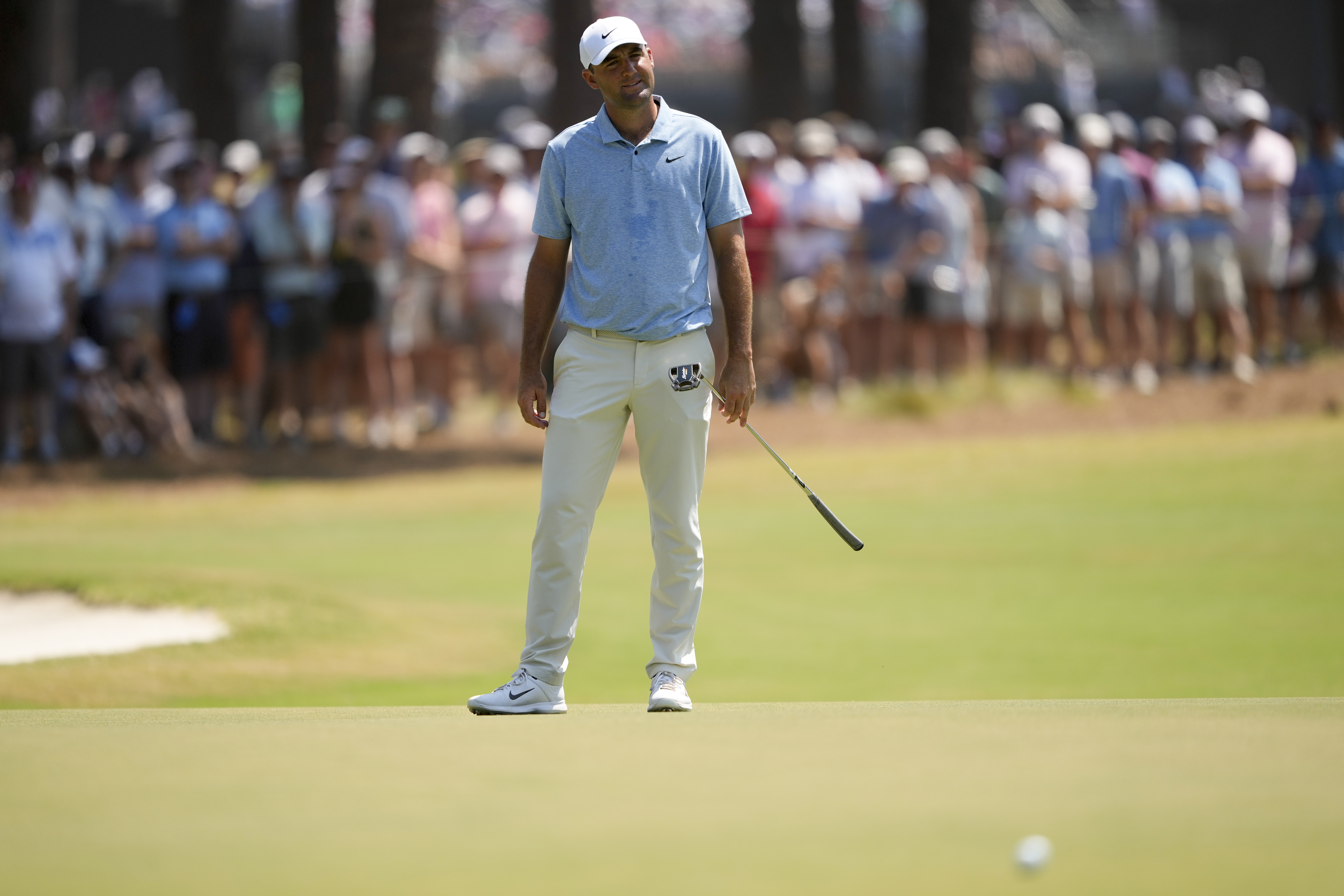 Scottie Scheffler reacts after missing a putt on the seventh hole during the third round of the U.S. Open golf tournament Saturday, June 15, 2024, in Pinehurst, N.C.