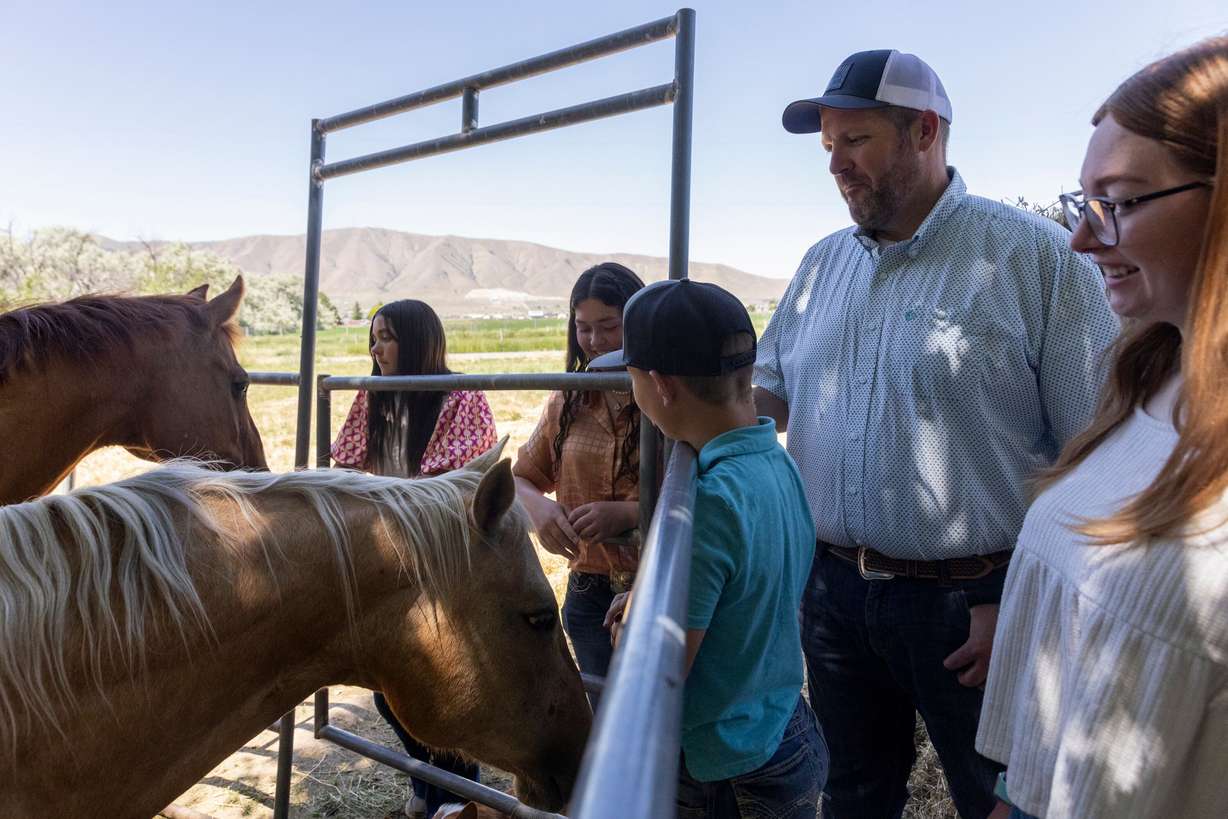 Brody Lambert and his kids, Ashlee, Haylee, Porter and Brinlee, spend time outside together at their home in Benjamin on Thursday.