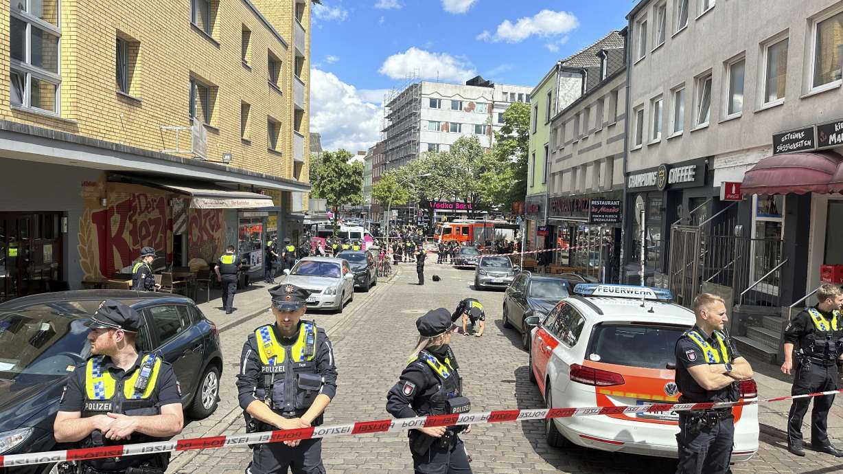 Police cordon off an area near the Reeperbahn in Hamburg, Germany, Sunday, June 16, 2024. German police say officers have shot and wounded a man who was threatening them with an axe and a firebomb in the northern city of Hamburg, hours before the city hosts a match in the Euro 2024 soccer tournament.