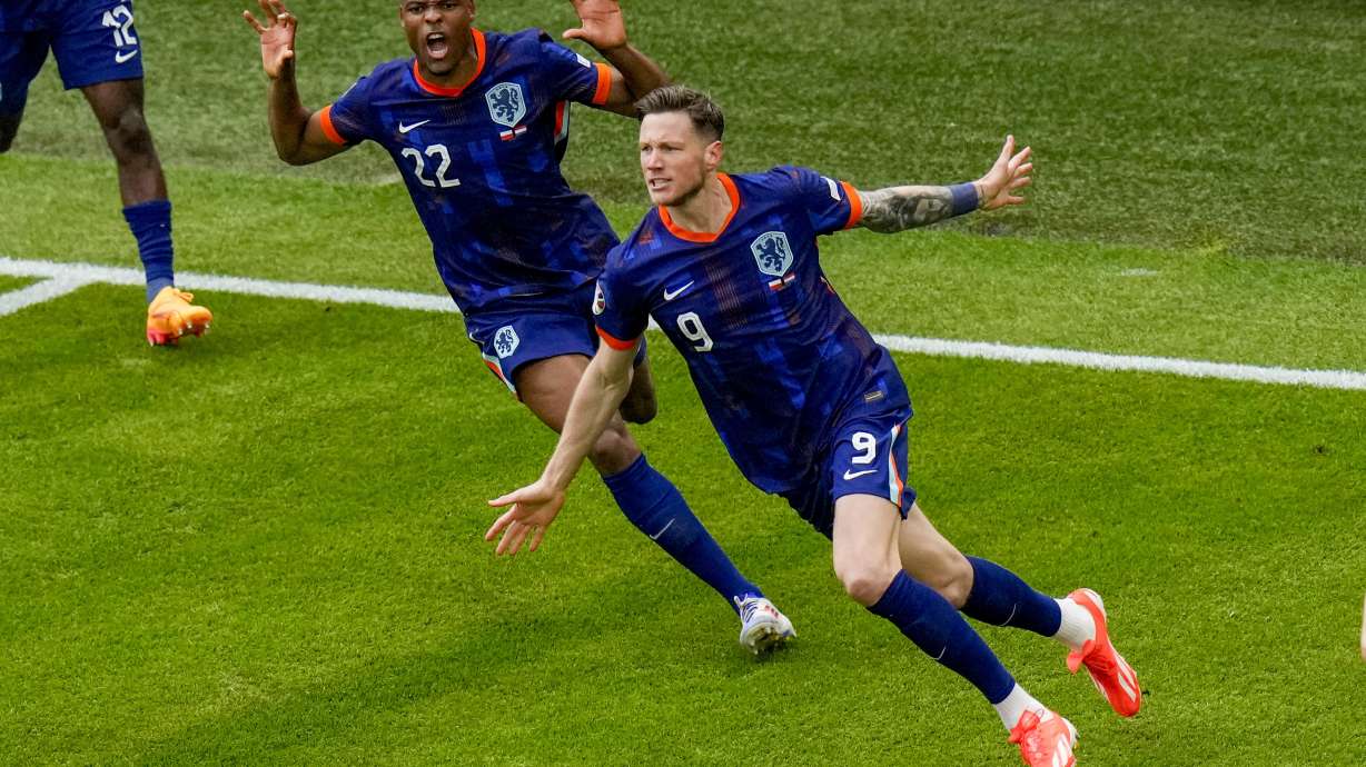 Wout Weghorst of the Netherlands, right, celebrates his side's second goal with his team mates during a Group D match between Poland and the Netherlands at the Euro 2024 soccer tournament in Hamburg, Germany, Sunday, June 16, 2024.