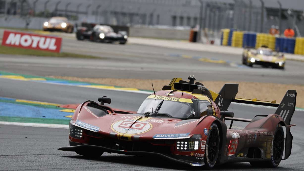 The Ferrari Corse team car driven by Italy's Antonio Fuoco, Spain's Miguel Molina and Denmark's Nicklas Nielsen takes a curve during the 24-hour Le Mans endurance race in Le Mans, western France, Sunday, June 16, 2024.