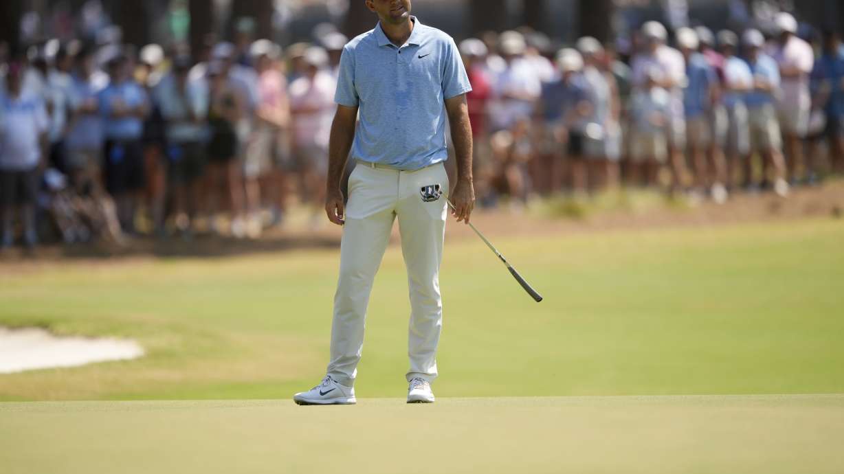 Scottie Scheffler reacts after missing a putt on the seventh hole during the third round of the U.S. Open golf tournament Saturday, June 15, 2024, in Pinehurst, N.C.