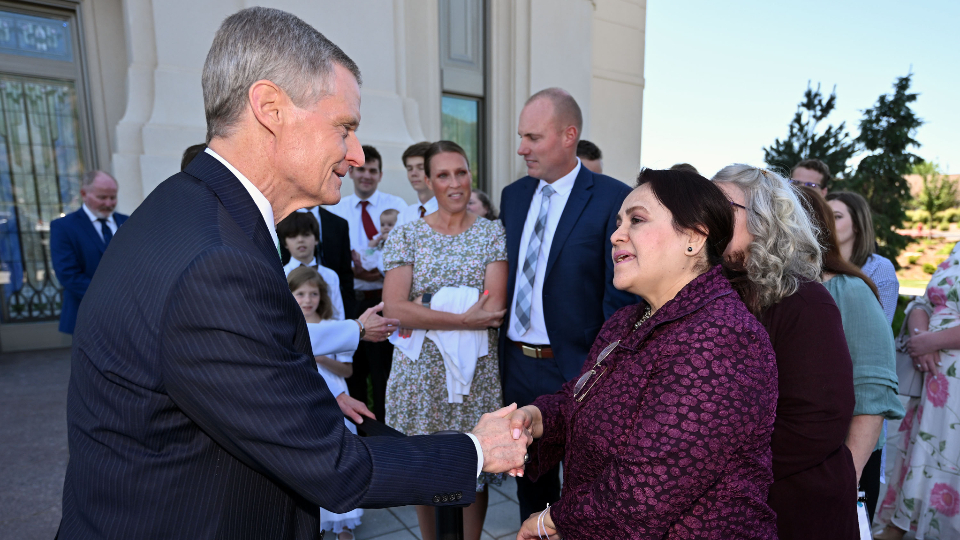 Elder David A. Bednar of the Quorum of the Twelve Apostles and his wife, Sister Susan Bednar, greet members after the dedication of the Layton Utah Temple on Sunday.