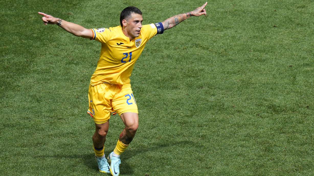 Romania's Nicolae Stanciu celebrates after scoring the opening goal against Ukraine during a Group E match between Romania and Ukraine at the Euro 2024 soccer tournament in Munich, Germany, Monday, June 17, 2024.