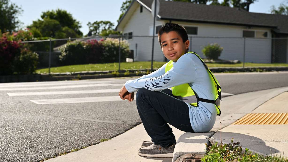 Hector Lara near South Kearns Elementary School on Monday, where he is a patroller. He was awarded the AAA School Safety Patrol Lifesaving Medal for select patrollers who, while on duty, have saved the life of a person in imminent danger.