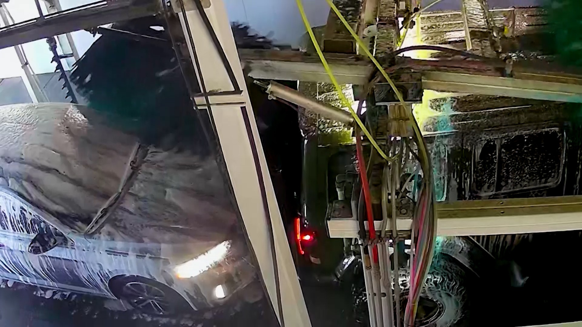 A camera inside the Quick Quack Car Wash tunnel shows Lynzee Delapaz’s Volkswagen being pulled into the back of the Jeep ahead of her in this undated image.