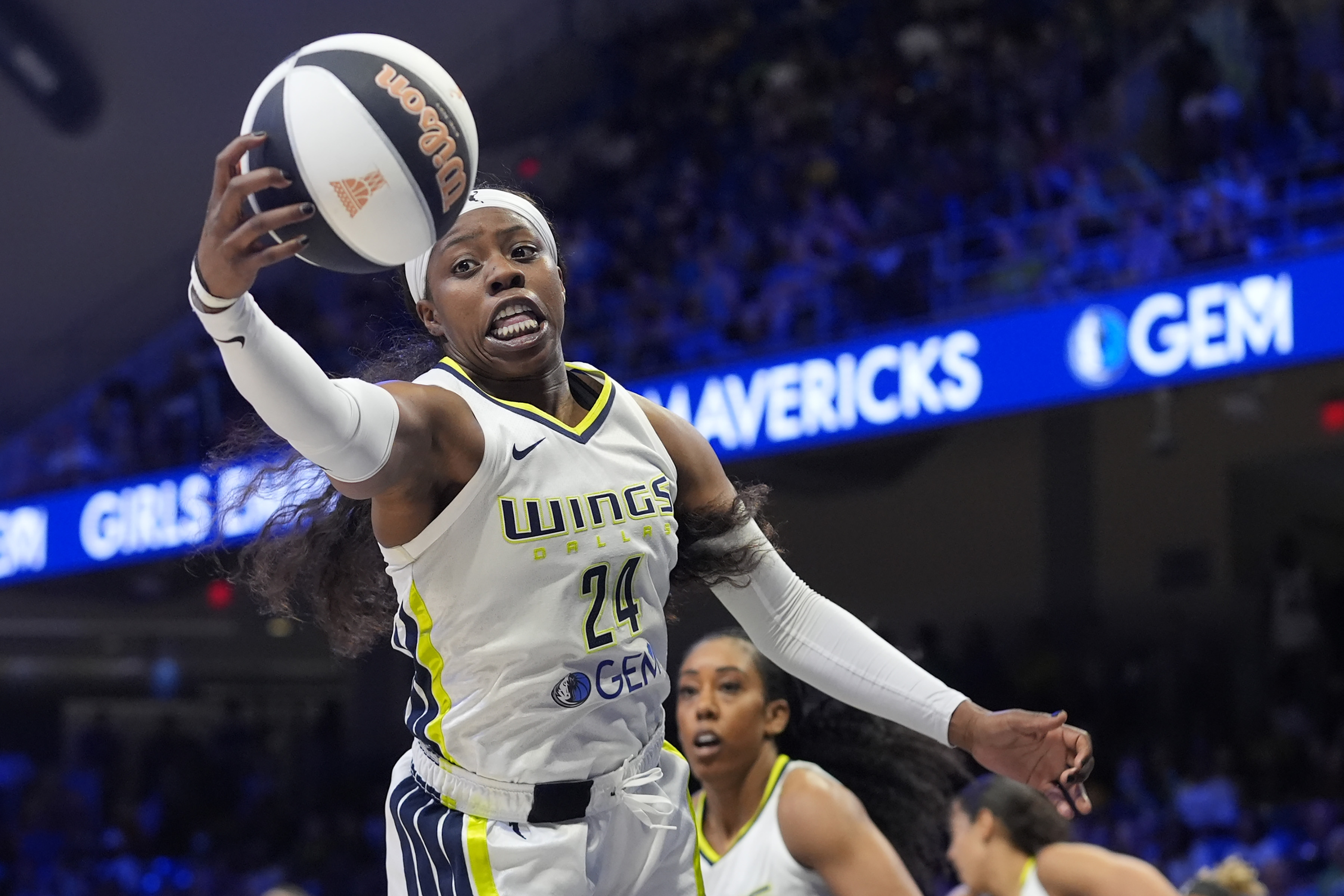 Dallas Wings guard Arike Ogunbowale (24) reaches for a rebound during the first half of the team's WNBA basketball basketball game against the Seattle Storm in Arlington, Texas, Thursday, June 13, 2024. 