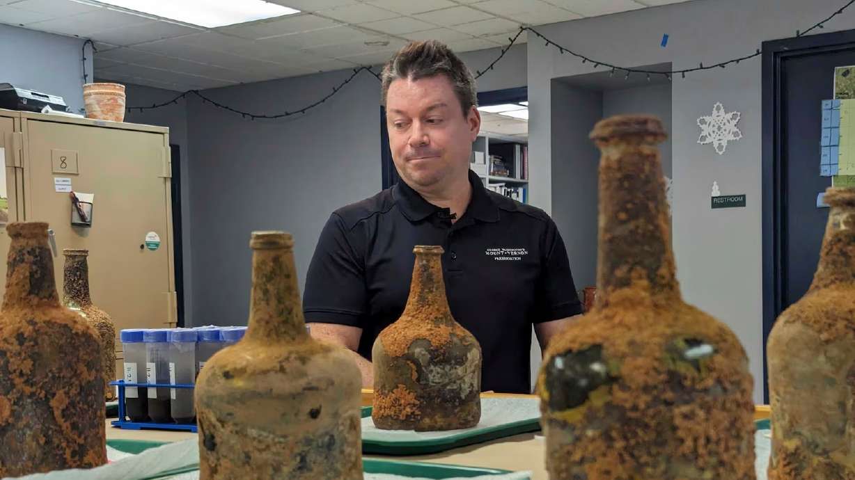 Archeologist Jason Boroughs discusses artifacts found underneath George Washington's home in Mount Vernon, Va., Monday. Earlier this year, a few dozen 18th-century glass bottles containing fruit were unearthed in Washington's mansion cellar.