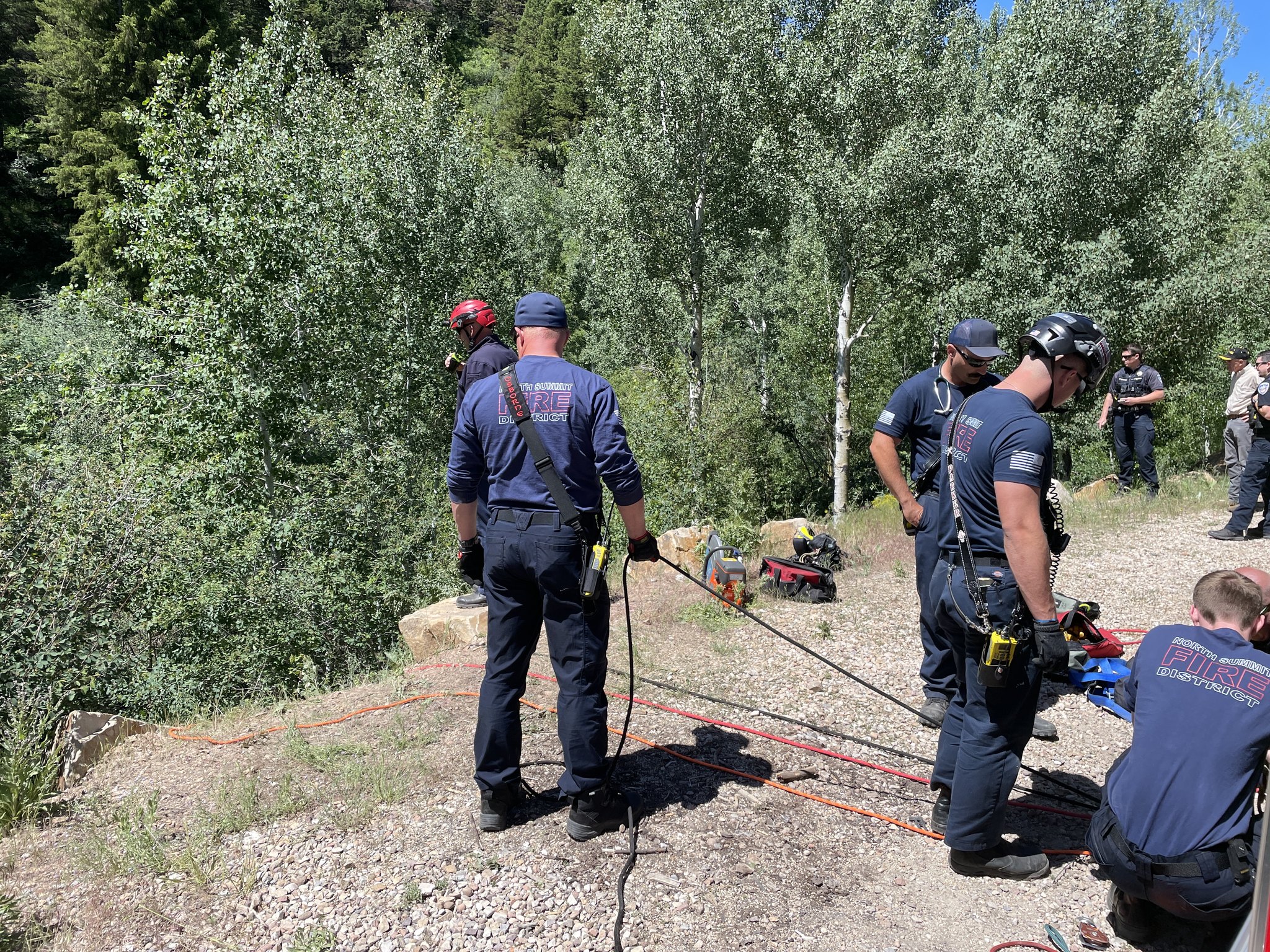 North Summit Fire District firefighters extricate a dump truck driver who was pinned after his or her truck fell 200 feet Tuesday morning.