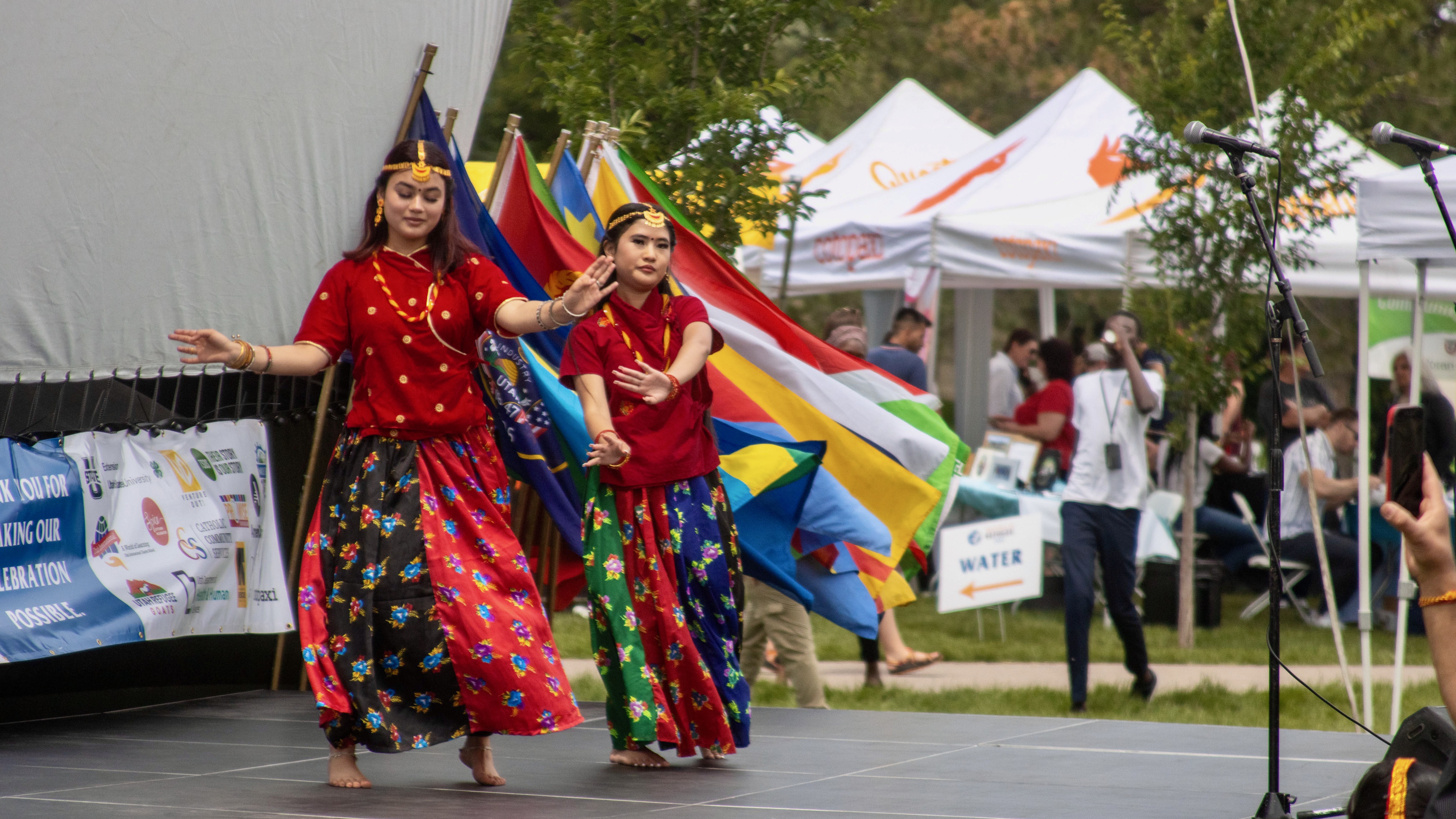 The photo shows participants in a performance at a World Refugee Day event held in June 2023 at Millcreek and hosted by the Utah Department of Workforce Services.