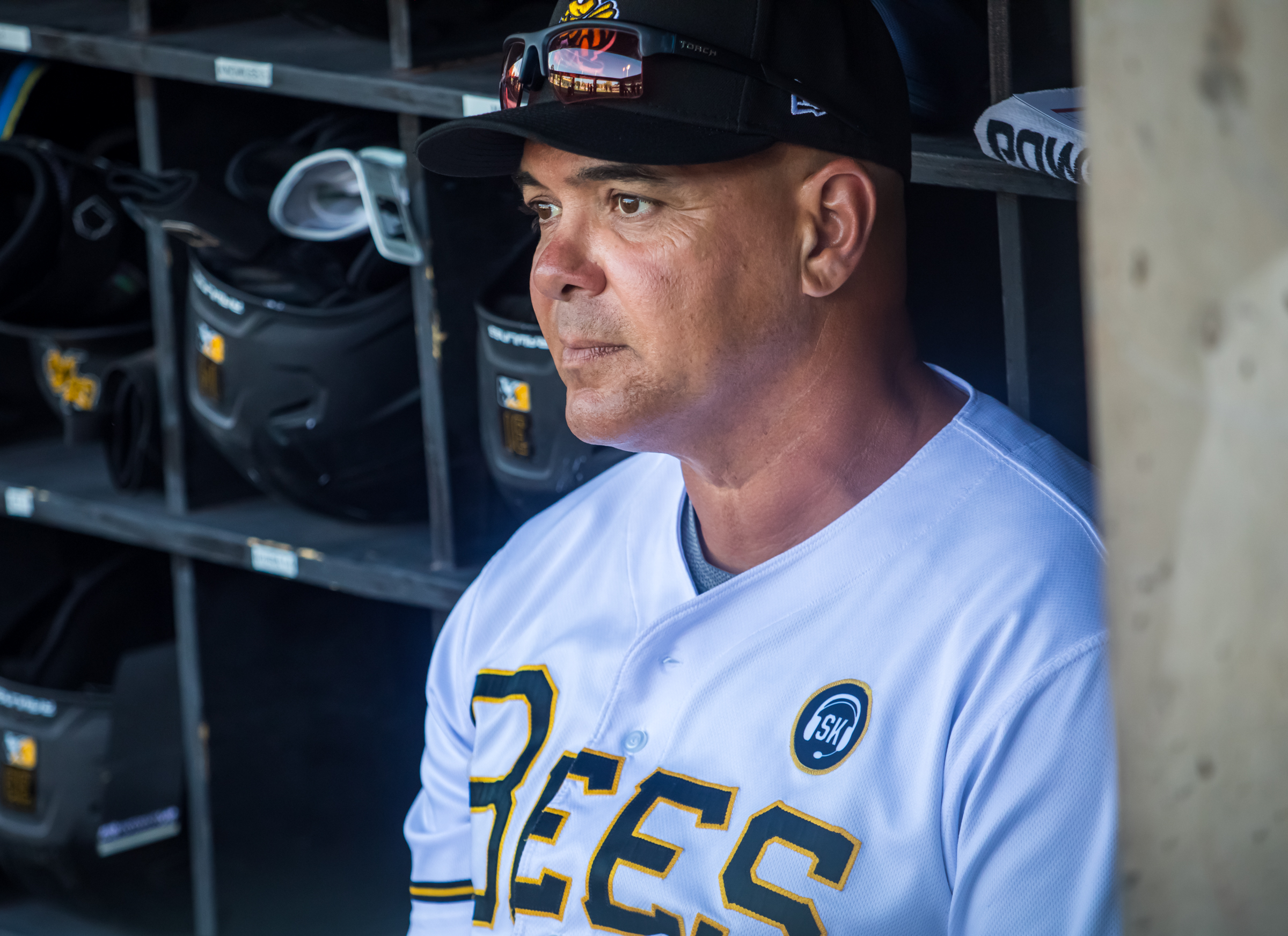 Salt Lake Bees manager Keith Johnson sits in the Bees dugout before the team's game against the Reno Aces at Smith's Ballpark on Tuesday. The team added a patch on the chest of the chest of its primary jerseys honoring Steve Klauke after his death last week.