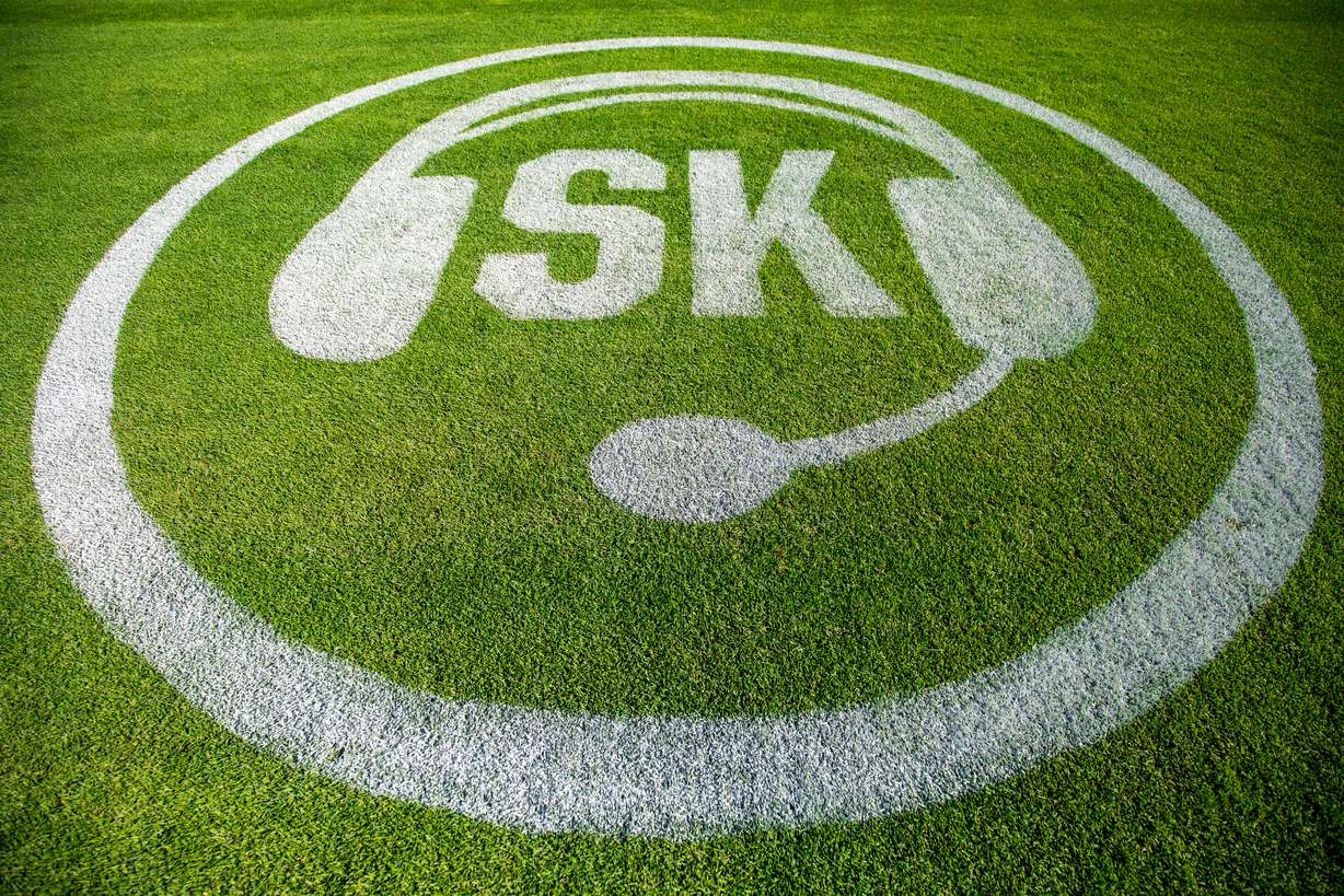 A logo honoring painted onto the third-base line of Smith's Ballpark on Tuesday.
