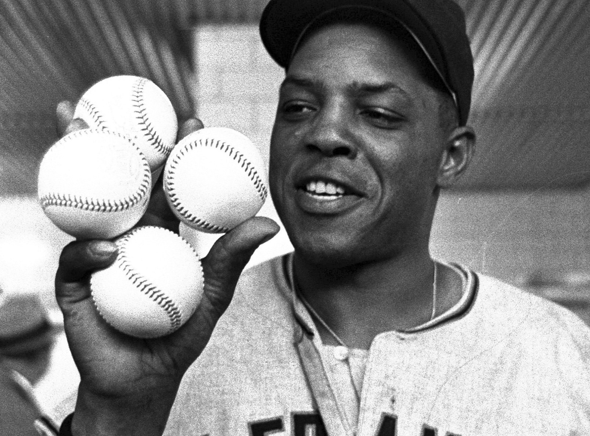 FILE - San Francisco Giants outfielder Willie Mays displays the four baseballs in the clubhouse representing the four homers which he hit against the Milwaukee Braves, April 30, 1961, in Milwaukee. Mays, the electrifying “Say Hey Kid” whose singular combination of talent, drive and exuberance made him one of baseball’s greatest and most beloved players, has died. He was 93. Mays' family and the San Francisco Giants jointly announced Tuesday night, June 18, 2024, he had “passed away peacefully” Tuesday afternoon surrounded by loved ones. 