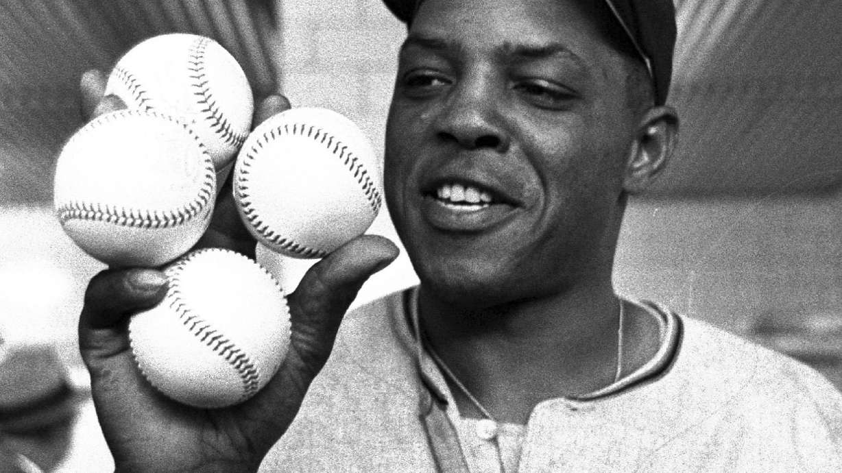 FILE - San Francisco Giants outfielder Willie Mays displays the four baseballs in the clubhouse representing the four homers which he hit against the Milwaukee Braves, April 30, 1961, in Milwaukee. Mays, the electrifying “Say Hey Kid” whose singular combination of talent, drive and exuberance made him one of baseball’s greatest and most beloved players, has died. He was 93. Mays' family and the San Francisco Giants jointly announced Tuesday night, June 18, 2024, he had “passed away peacefully” Tuesday afternoon surrounded by loved ones.