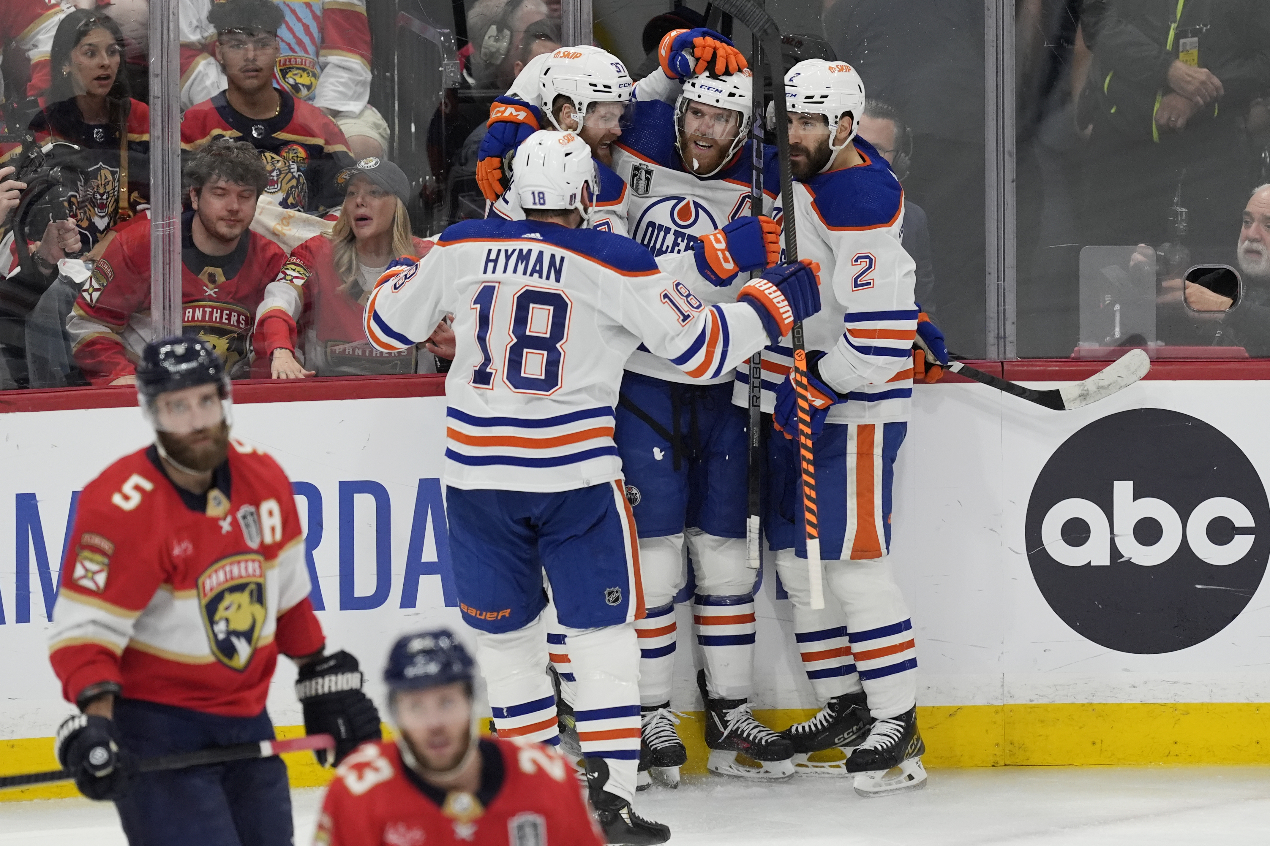 Edmonton Oilers center Connor McDavid (97), is congratulated by his teammates after scoring a goal during the second period of Game 5 of the NHL hockey Stanley Cup Finals against the Florida Panthers, Tuesday, June 18, 2024, in Sunrise, Fla.