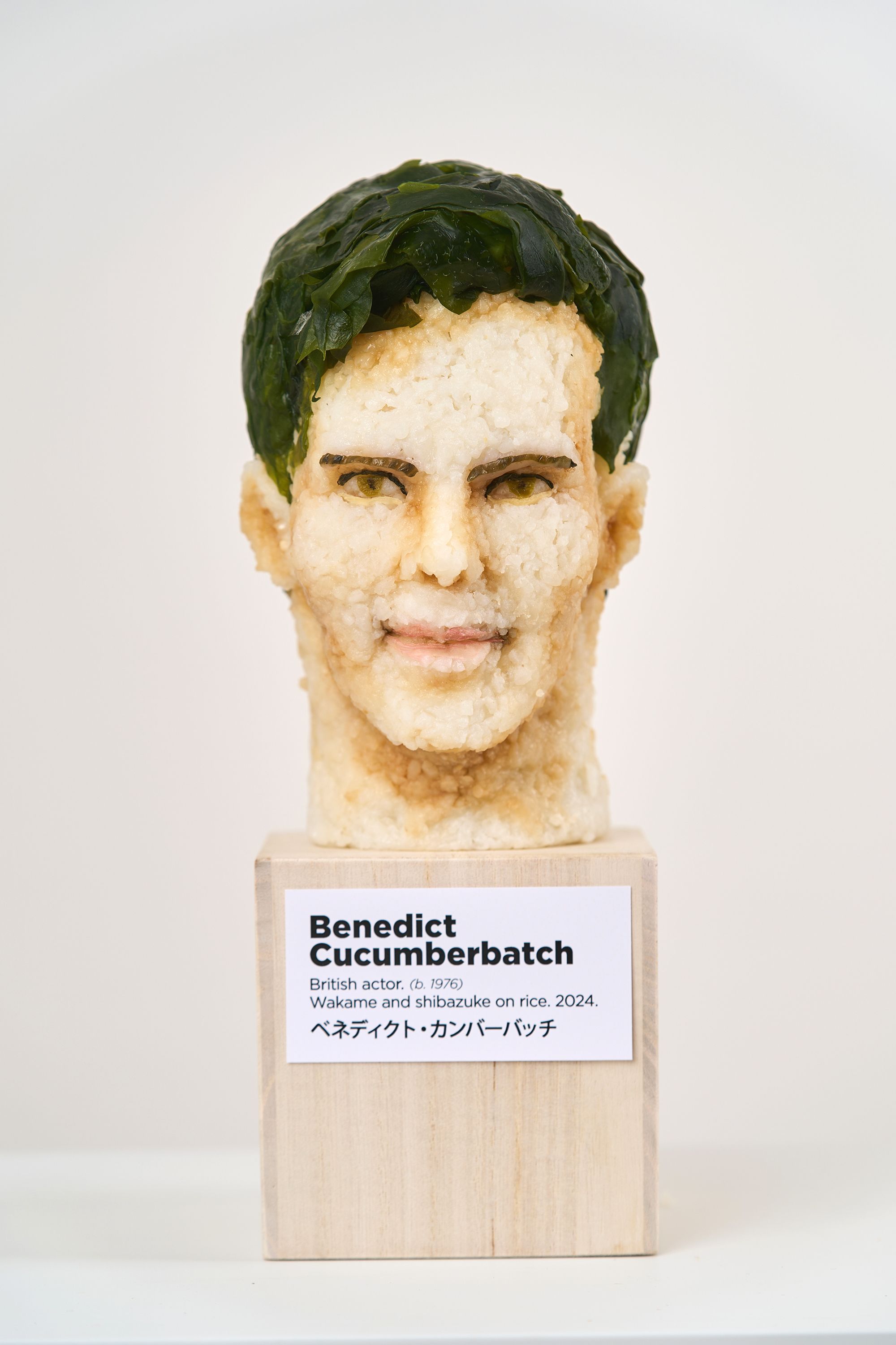 "Benedict Cucumberbatch" is pictured here. A woman is sculpting celebrity busts from sushi.