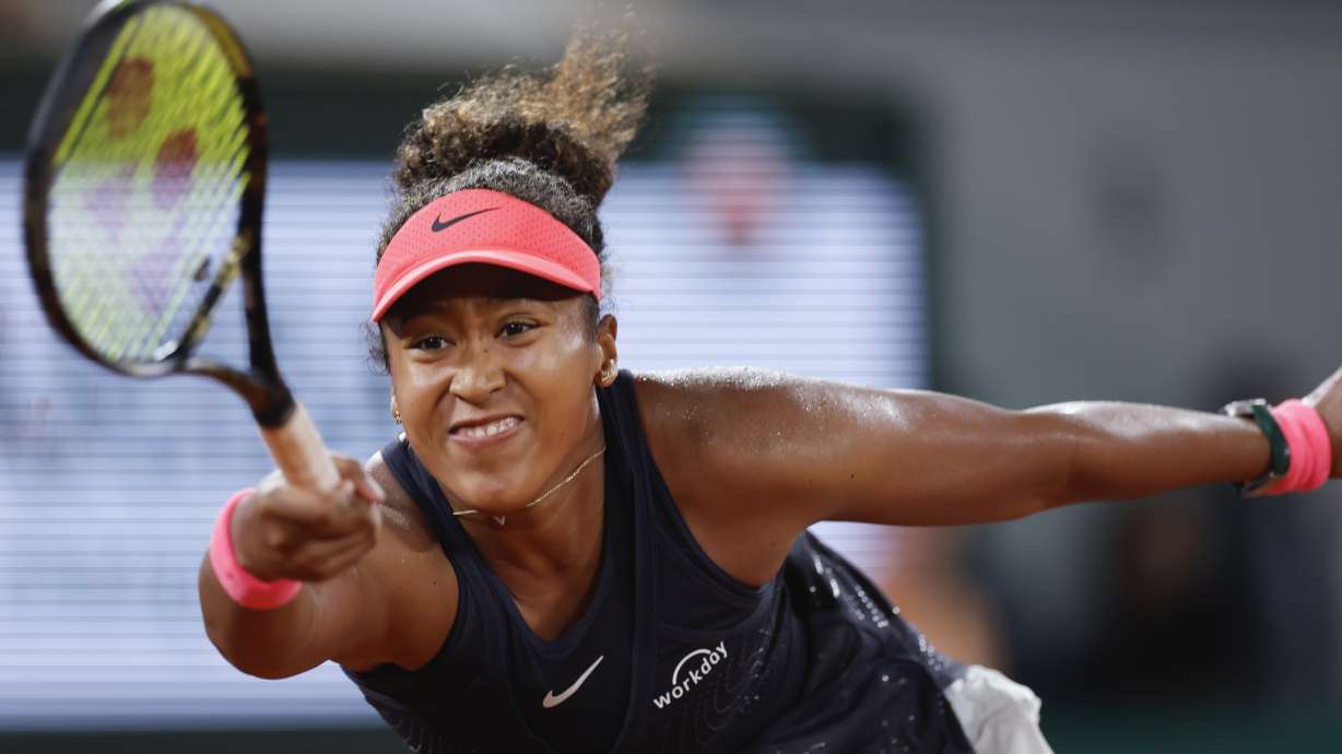 Japan's Naomi Osaka plays a shot against Poland's Iga Swiatek during their second round match of the French Open tennis tournament at the Roland Garros stadium in Paris, Wednesday, May 29, 2024.