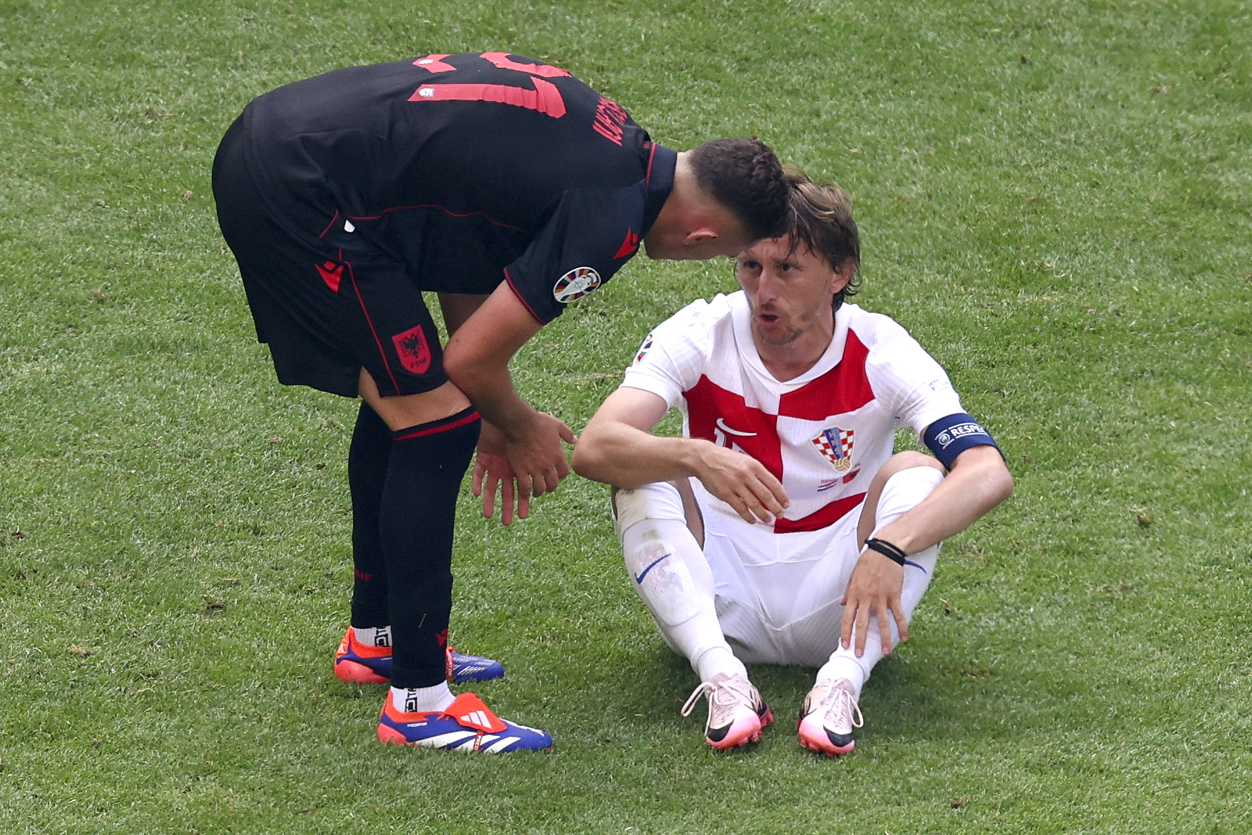 Albania's Kristjan Asllani, left, and Croatia's Luka Modric, right, talk after a Group B match between Croatia and Albania at the Euro 2024 soccer tournament in Hamburg, Germany, Wednesday, June 19, 2024.