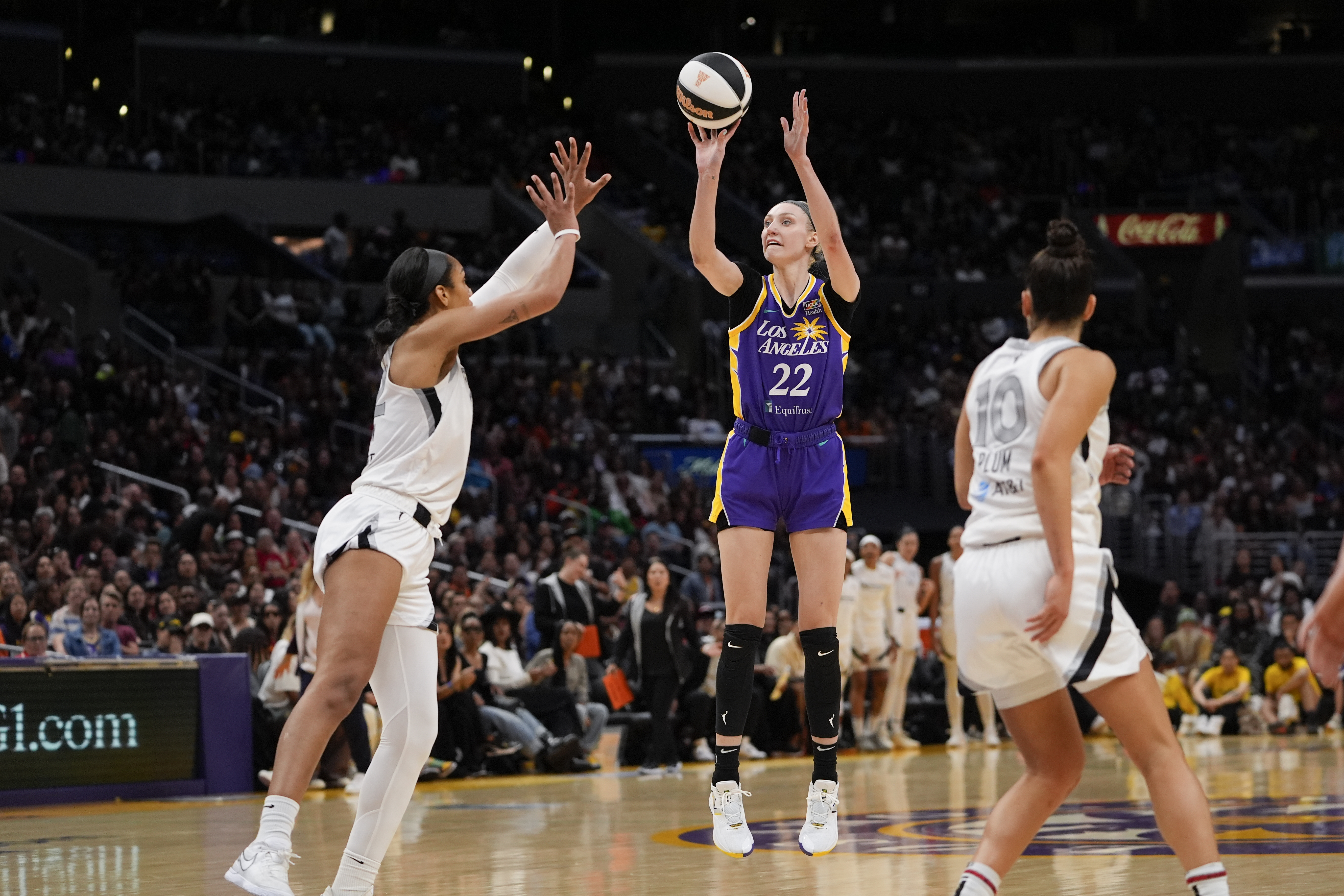 Los Angeles Sparks forward Cameron Brink (22) shoots against Las Vegas Aces center A'ja Wilson, left, and guard Kelsey Plum during the second half of a WNBA basketball game, Sunday, June 9, 2024, in Los Angeles. 