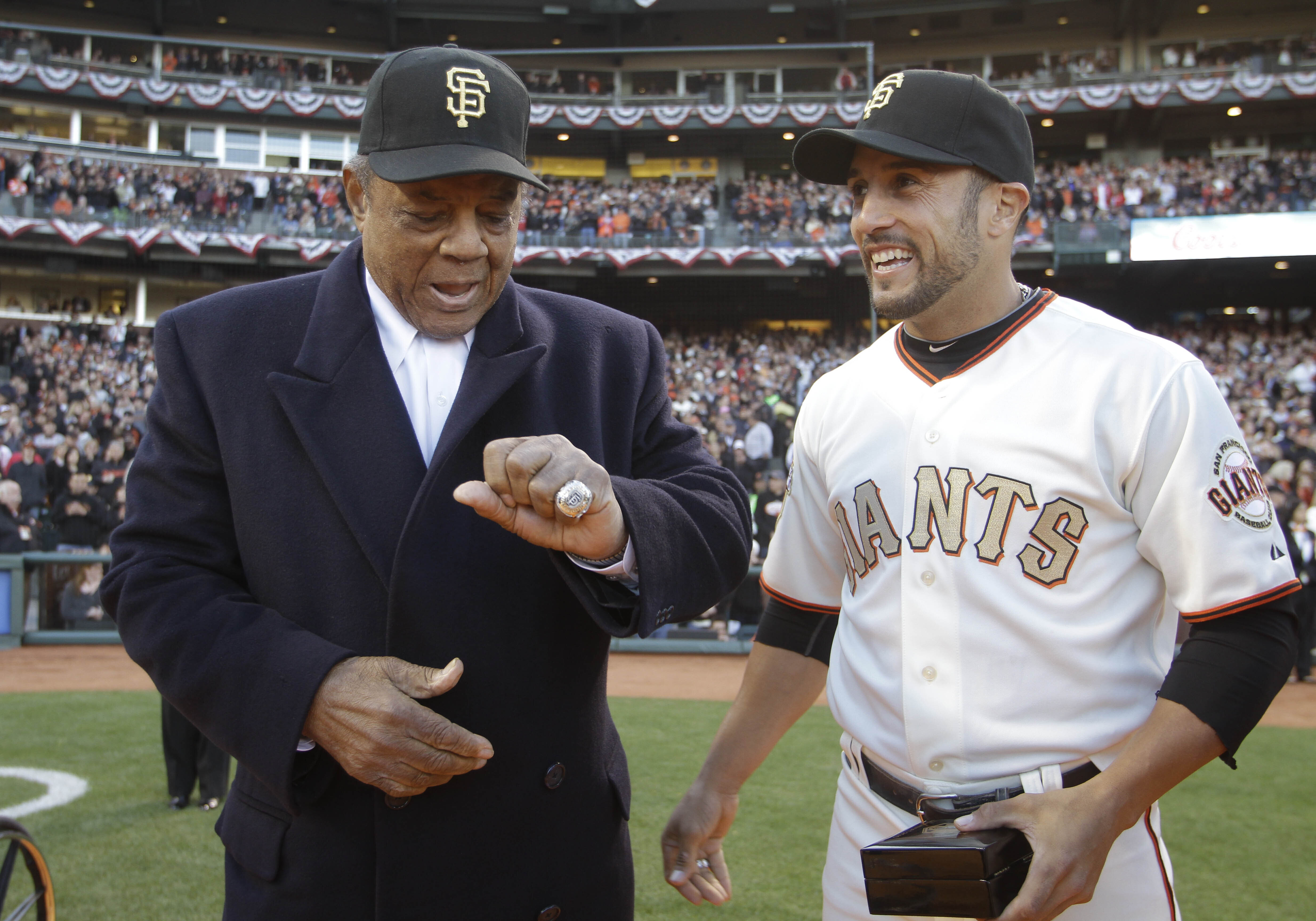 FILE - San Francisco Giants Hall of Famer Willie Mays, left, looks over his 2010 World Series championship ring that was presented to him by Giants center fielder Andres Torres, right, before their baseball game against the St. Louis Cardinals in San Francisco, Saturday, April, 9, 2011. Willie Mays, the electrifying “Say Hey Kid” whose singular combination of talent, drive and exuberance made him one of baseball’s greatest and most beloved players, has died. He was 93. Mays' family and the San Francisco Giants jointly announced Tuesday night, June 18, 2024, he had died earlier in the afternoon in the Bay Area.
