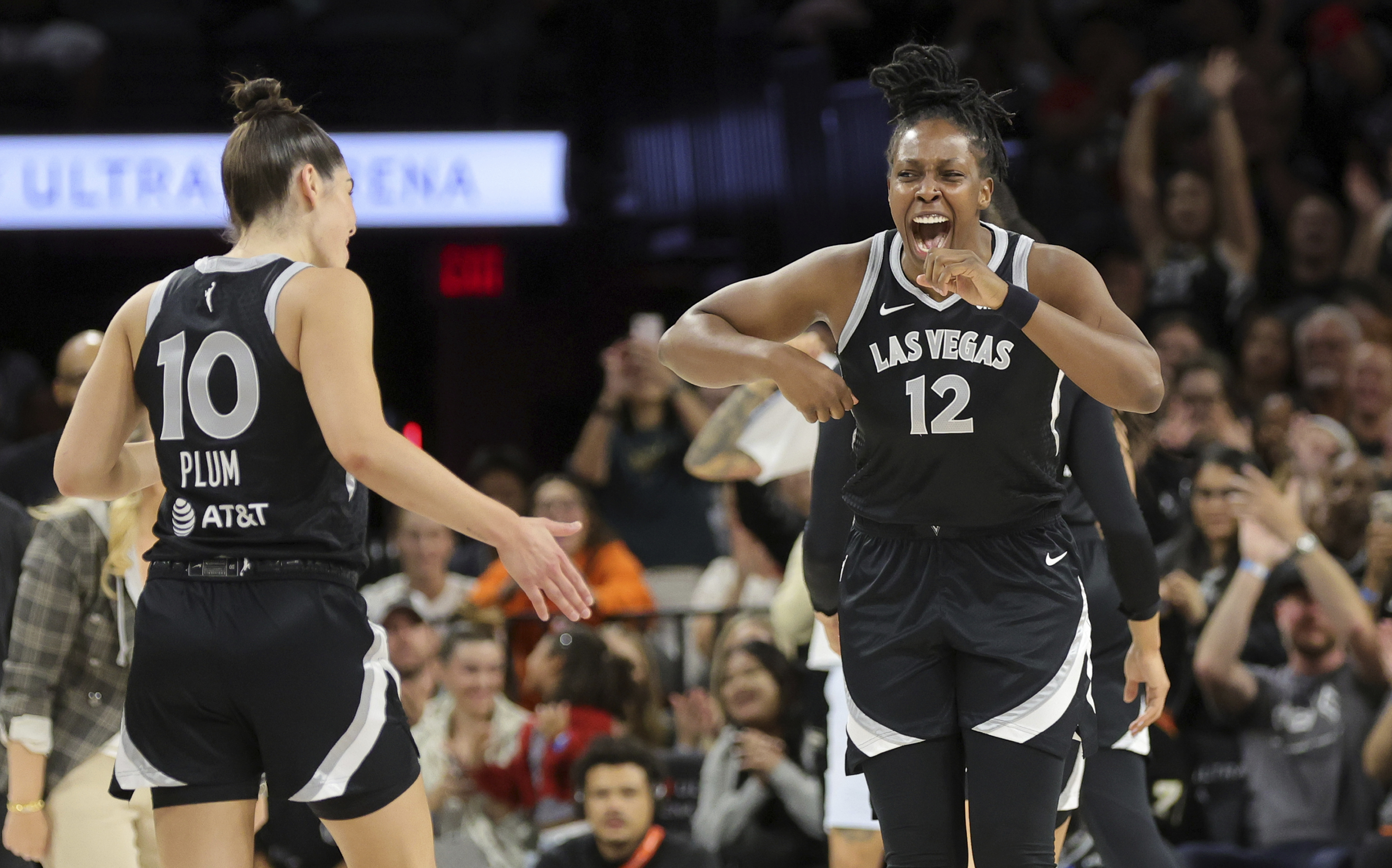Las Vegas Aces guards Chelsea Gray (12) and Kelsey Plum (10) celebrate a play during the first half of an WNBA basketball game against the Seattle Storm Wednesday, June 19, 2024, in Las Vegas. 