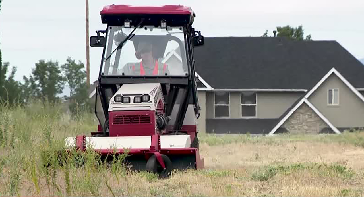 Crews mow weeds that could pose a fire hazard in Sandy on Wednesday. They are preparing for fire season in July.