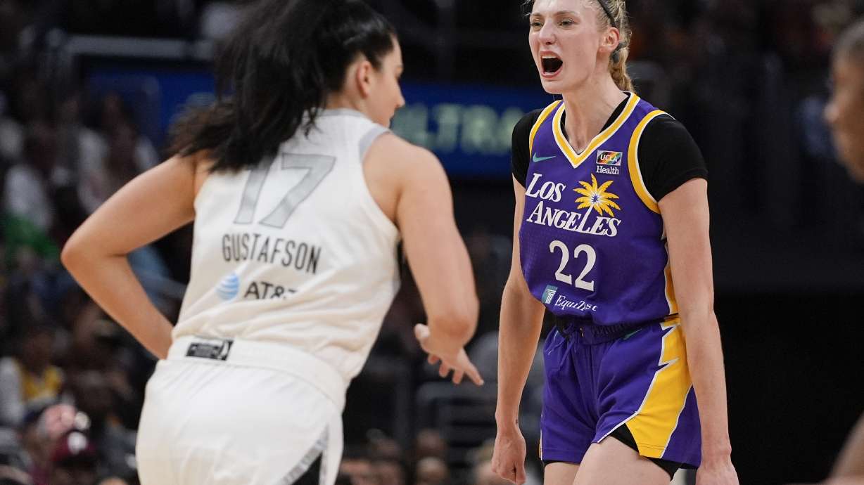 Los Angeles Sparks forward Cameron Brink (22) reacts near Las Vegas Aces center Megan Gustafson (17) after scoring a 3-point basket during the second half of a WNBA basketball game, Sunday, June 9, 2024, in Los Angeles.