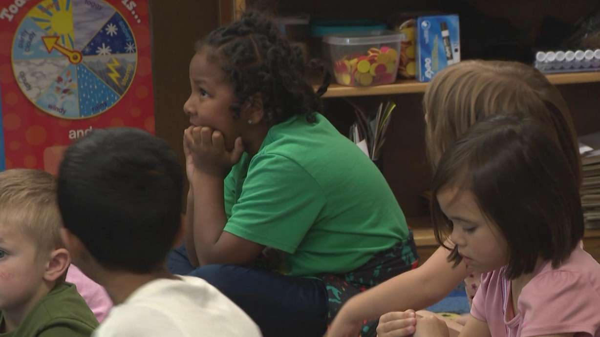 Students listen in a kindergarten class. Full-day kindergarten is increasing test scores.