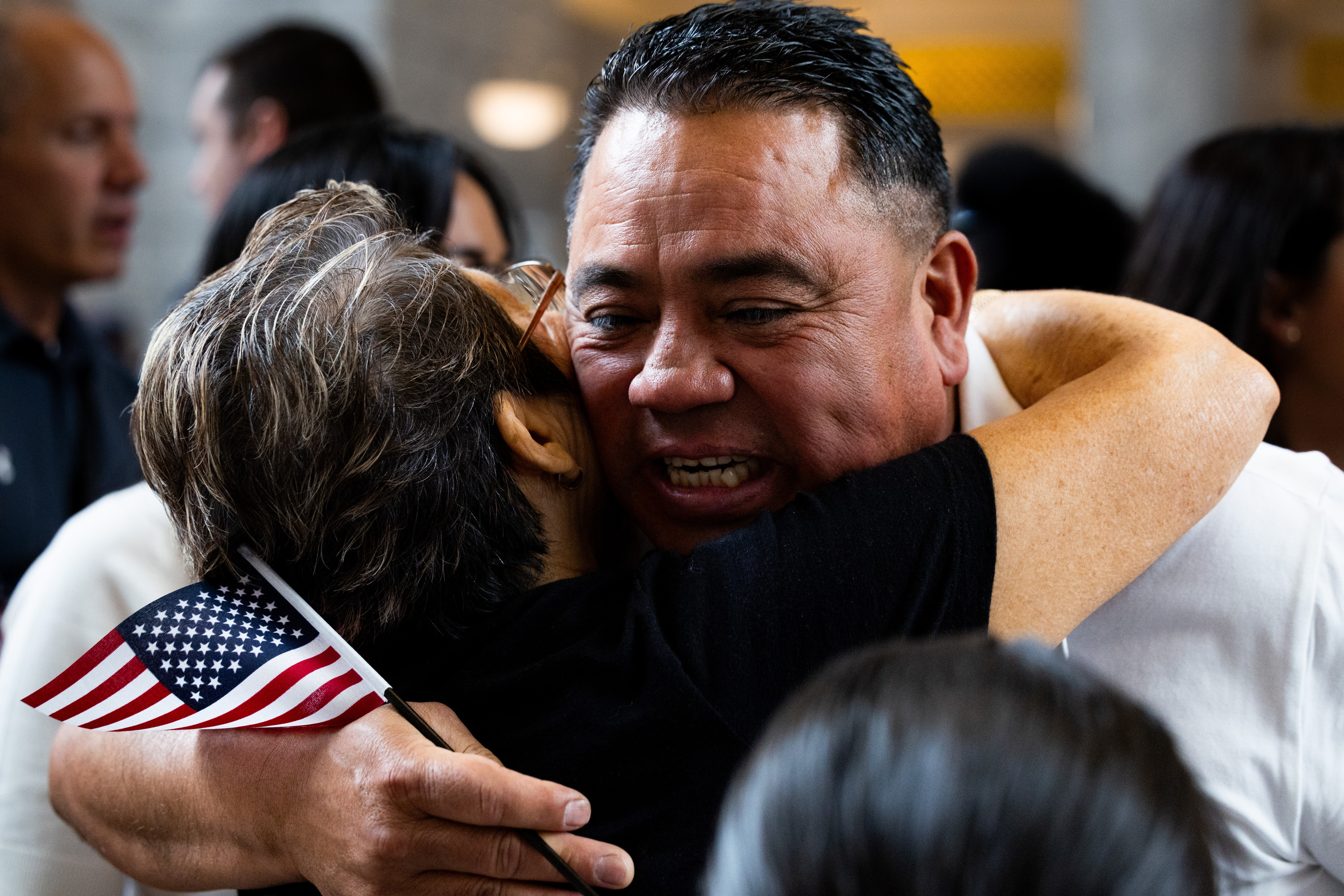 Alexander Cruz, of Ecuador, hugs friends and family after his naturalization ceremony at the Utah Capitol in Salt Lake City on Thursday. The ceremony kicked off World Refugee Day celebrations in Utah as 148 immigrants and refugees got their citizenship.