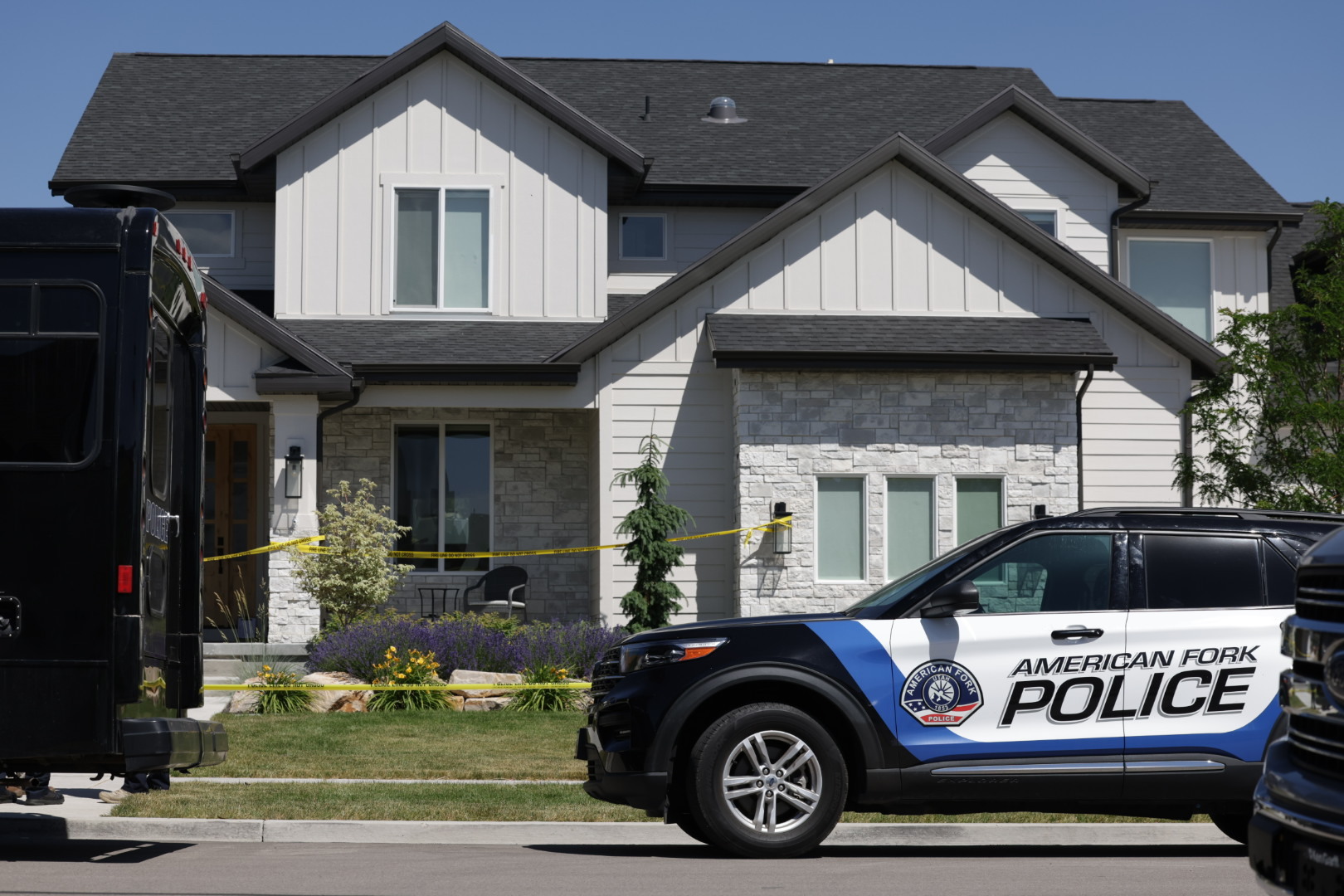Police vehicles are pictured in front of a home where two bodies, a husband and wife, were found in American Fork on Thursday. Police confirmed Friday the deaths were a murder-suicide.